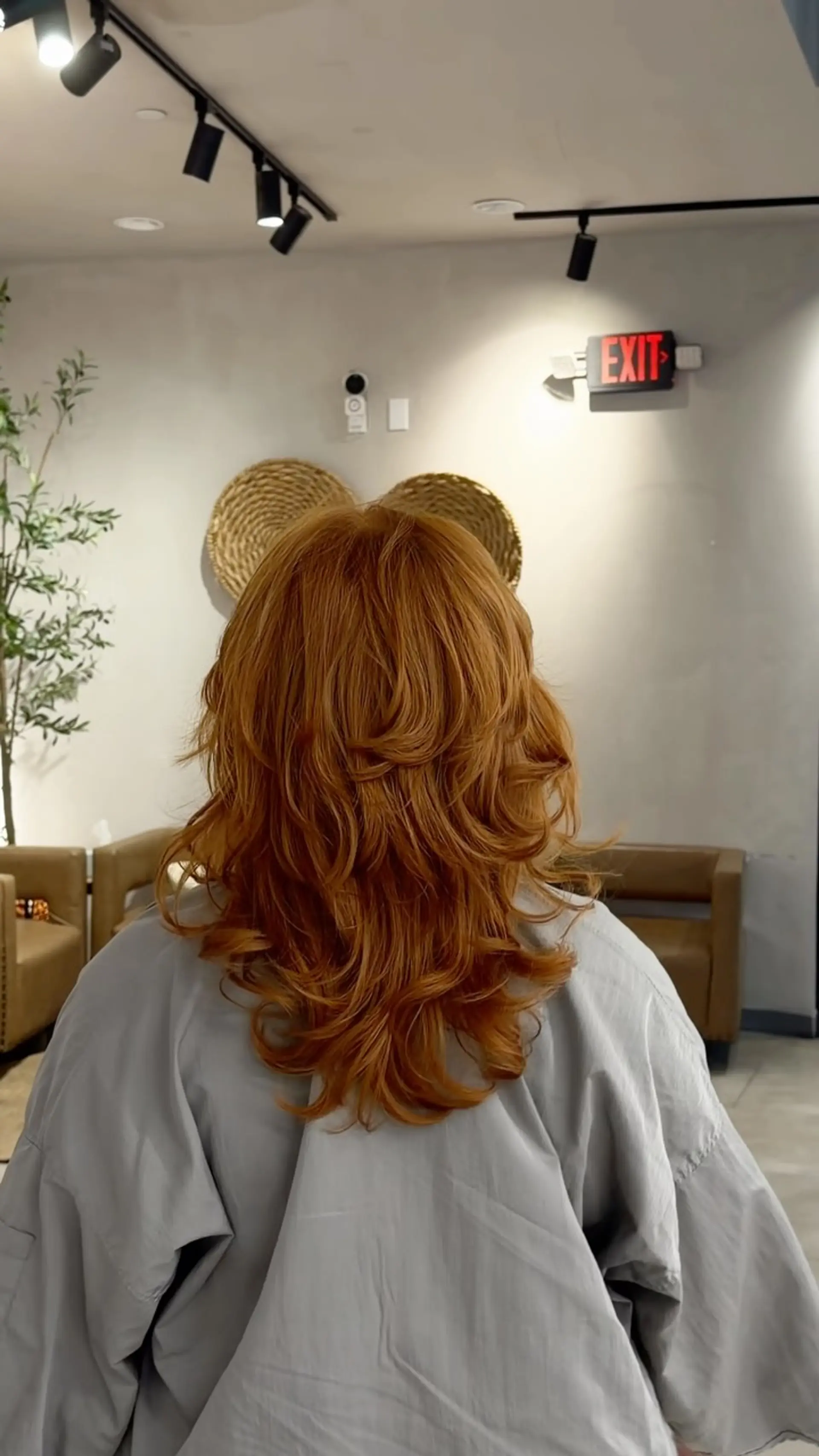 Long vibrant copper hair featuring heavy cascaded layers styled with bouncy, blown-out curved ends. 1