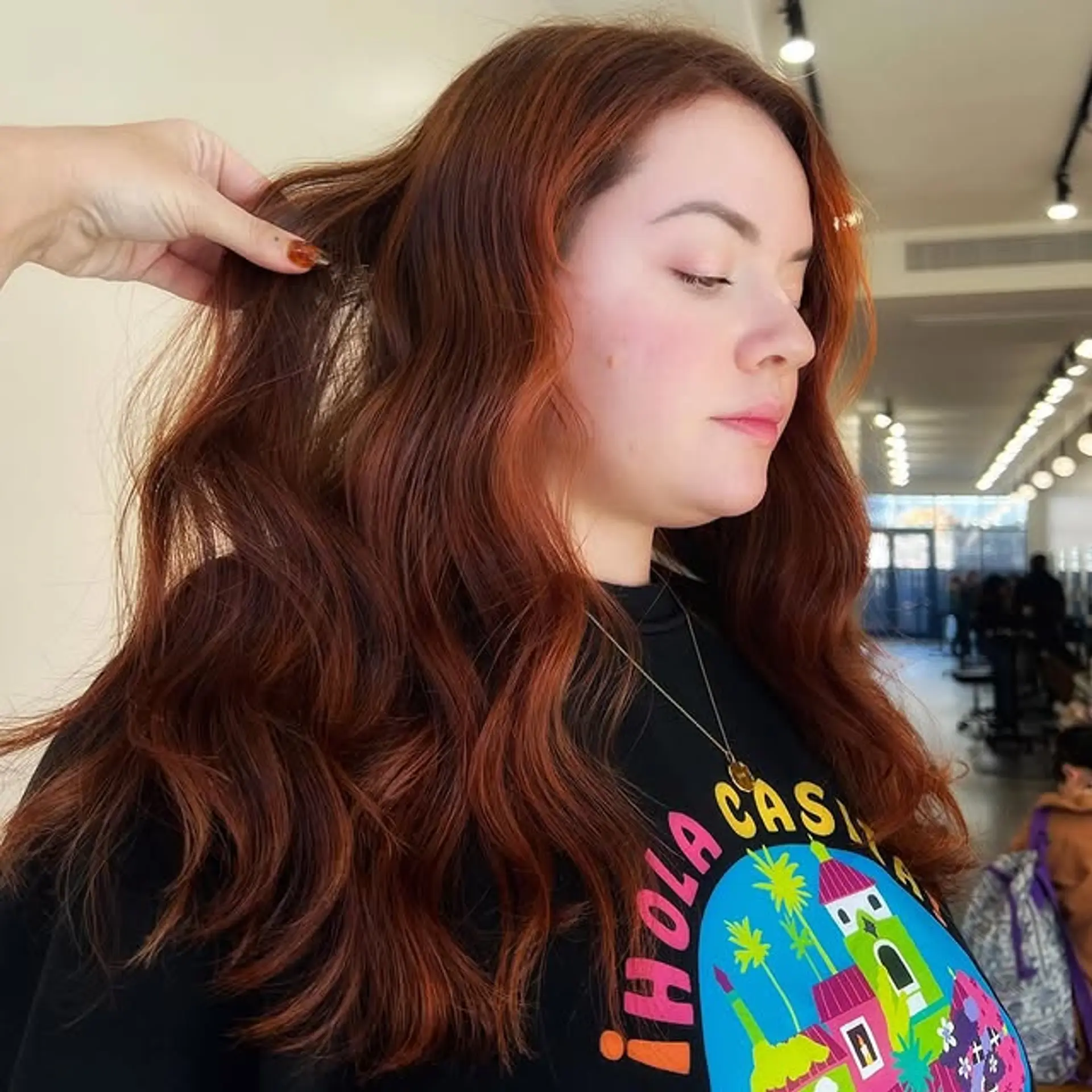Long, wavy auburn and copper hair with a balayage color technique. 1