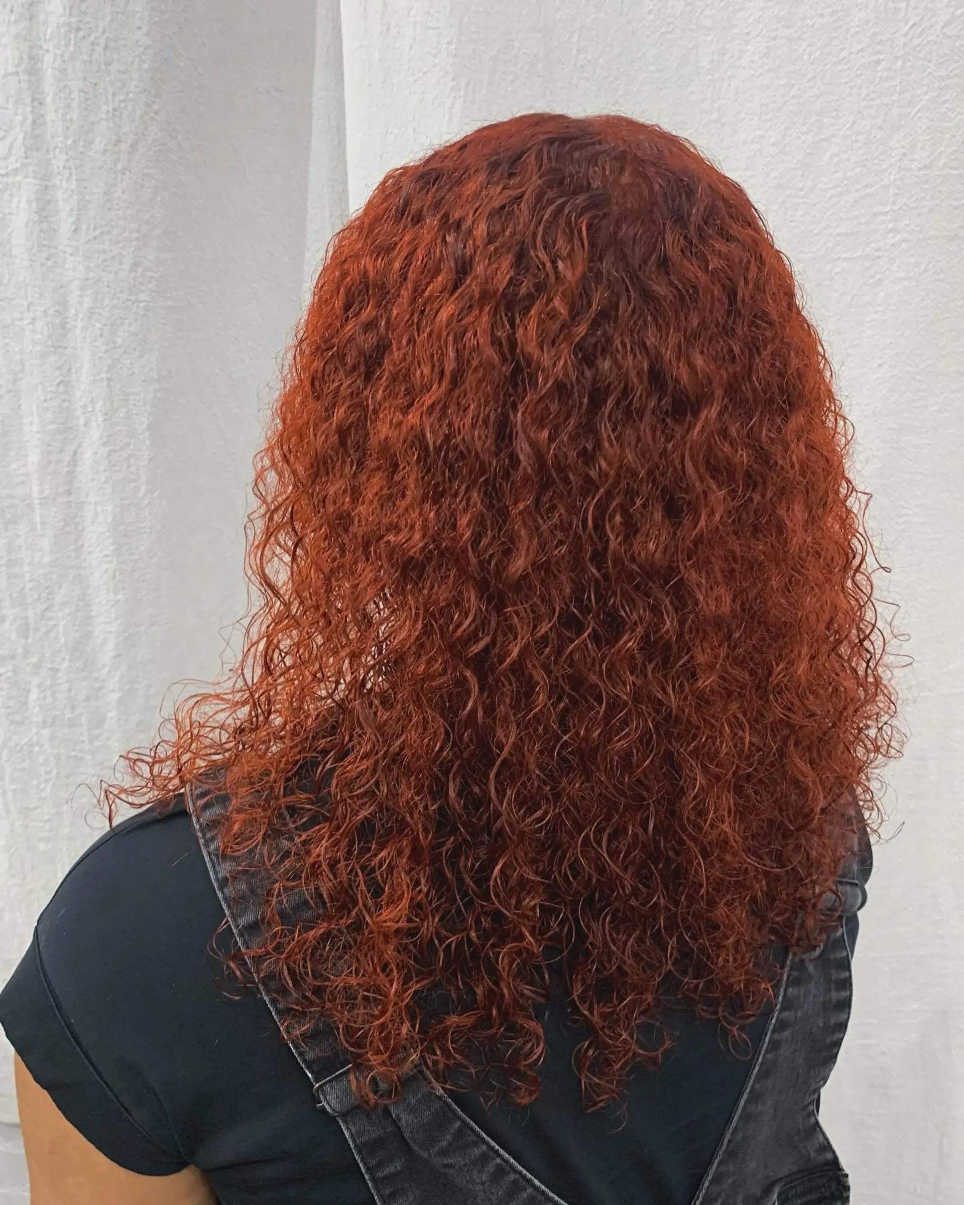 Medium-length curly hair in bold red and copper, with defined curls and voluminous texture. 4