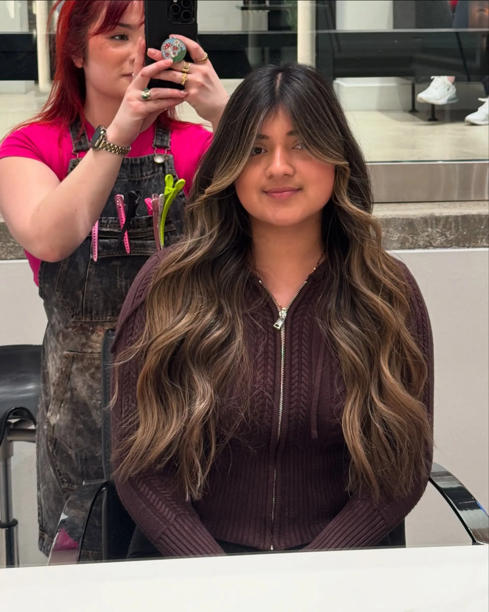 A long, wavy hairstyle with a beautiful balayage and face-framing curtain bangs. 5