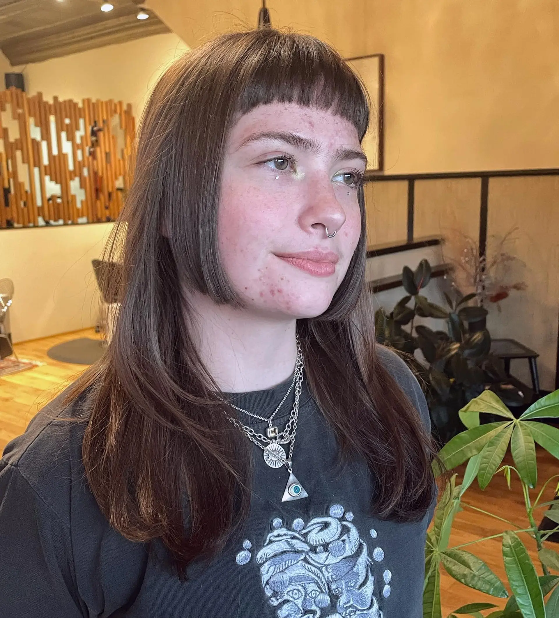 A medium-length shag with textured layers and blunt, short baby bangs. 1