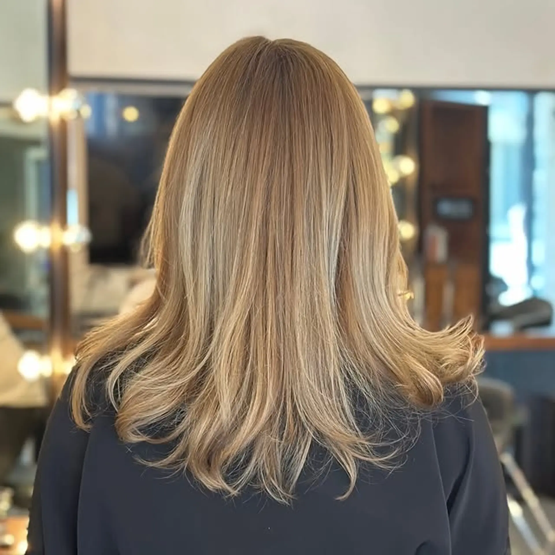 A layered medium length hairstyle with wavy ends. 1