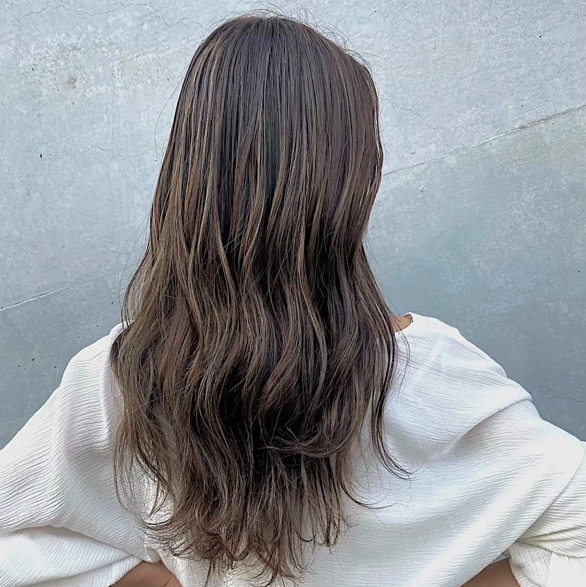 Long, layered wavy hairstyle with a bronde balayage. 1