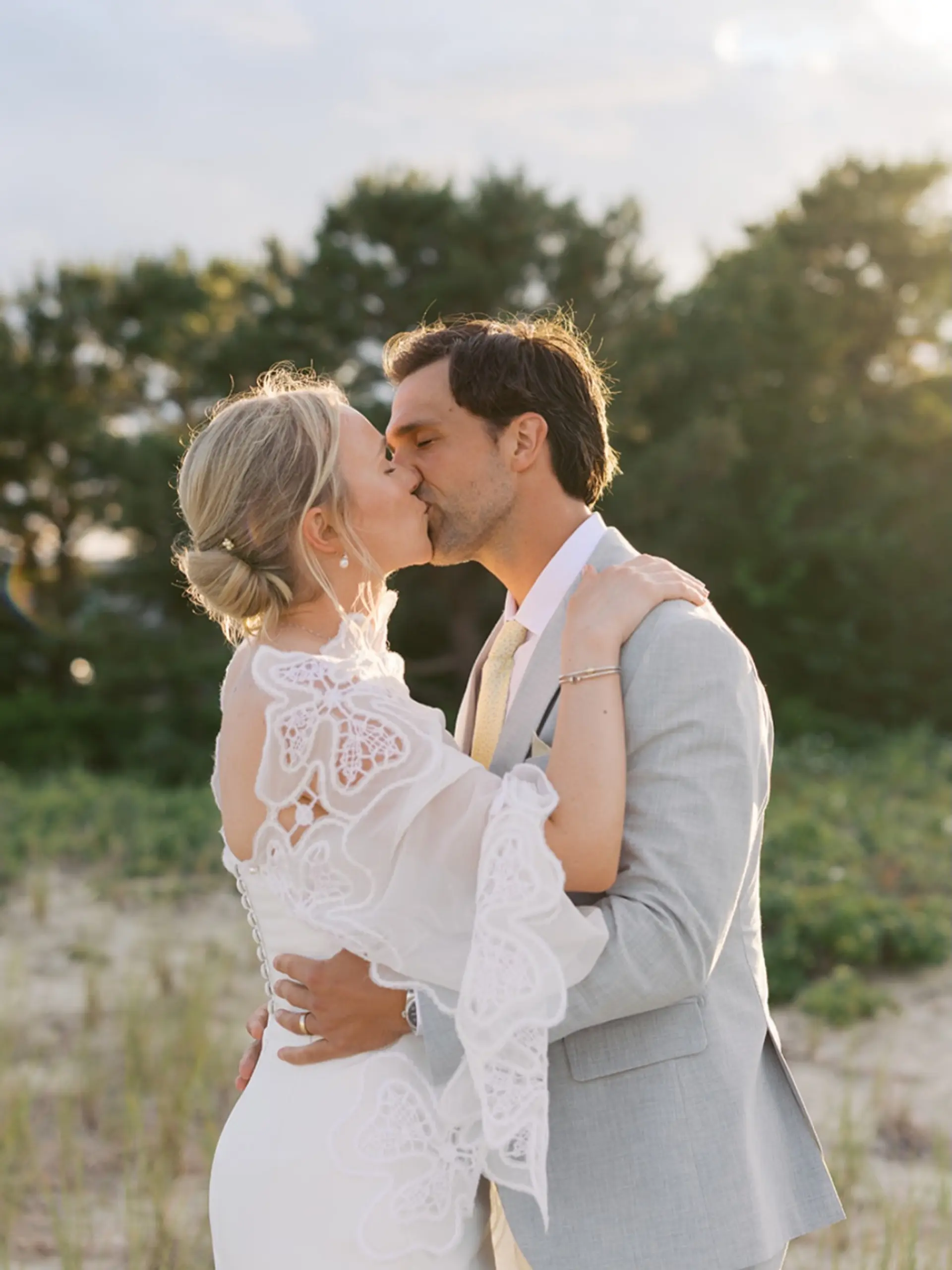 An elegant low bridal bun gathered softly at the nape of the neck. 1
