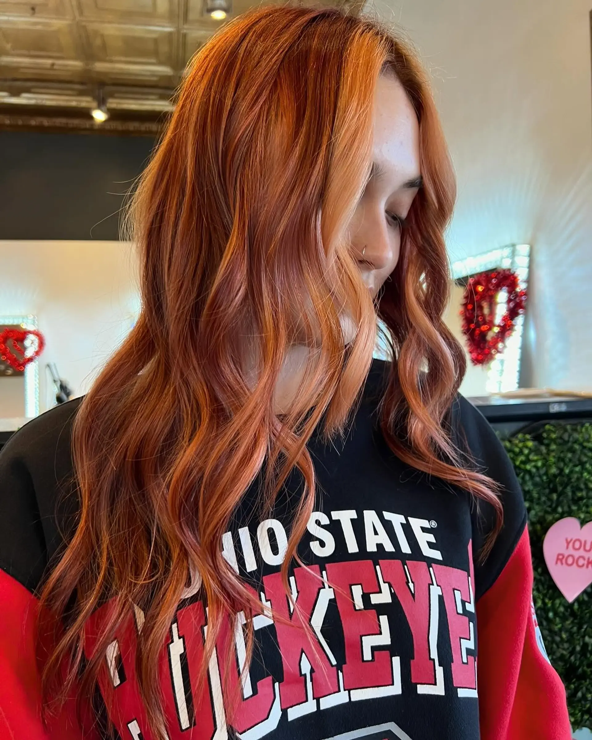 Long dimensional copper hair styled with soft, undone waves and lighter face-framing pieces. 1