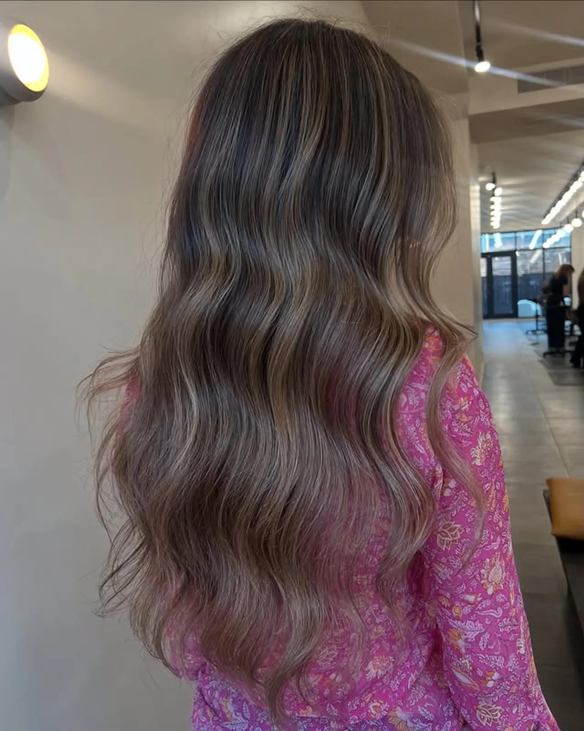 Long, wavy bronde balayage with subtle pink undertones. 1