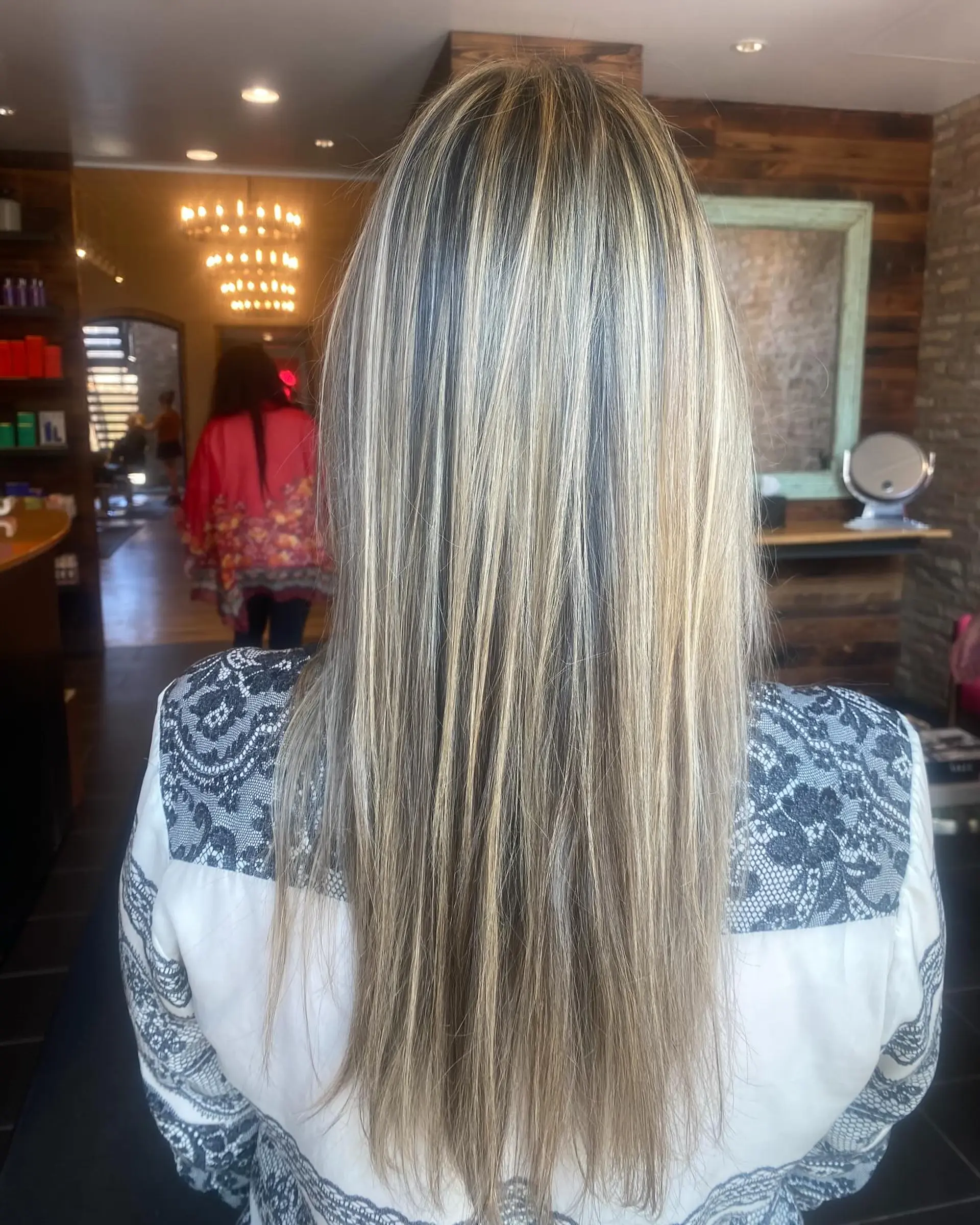 Long, straight hair with blonde balayage and natural brown roots. 1
