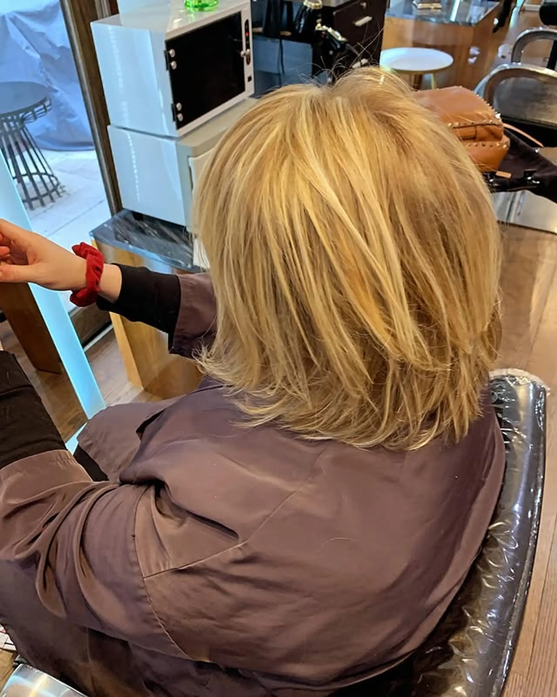 A textured, layered bob that sits at shoulder length, styled with face-framing layers. 1