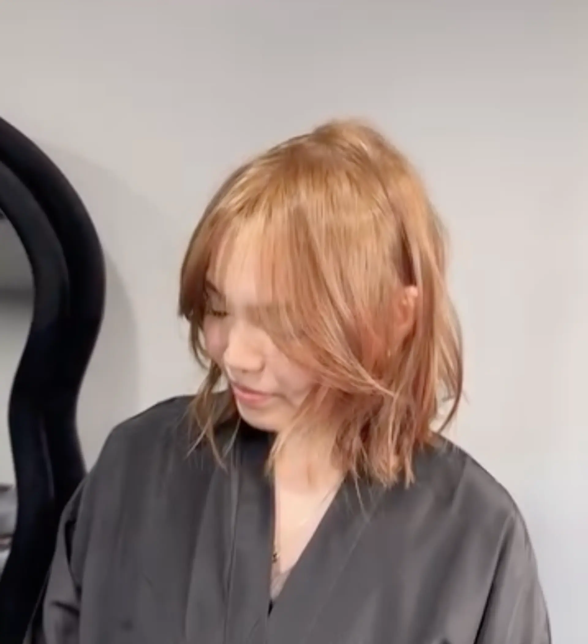 A medium-length, layered wavy rose gold bob with blunt ends and a middle part. 1
