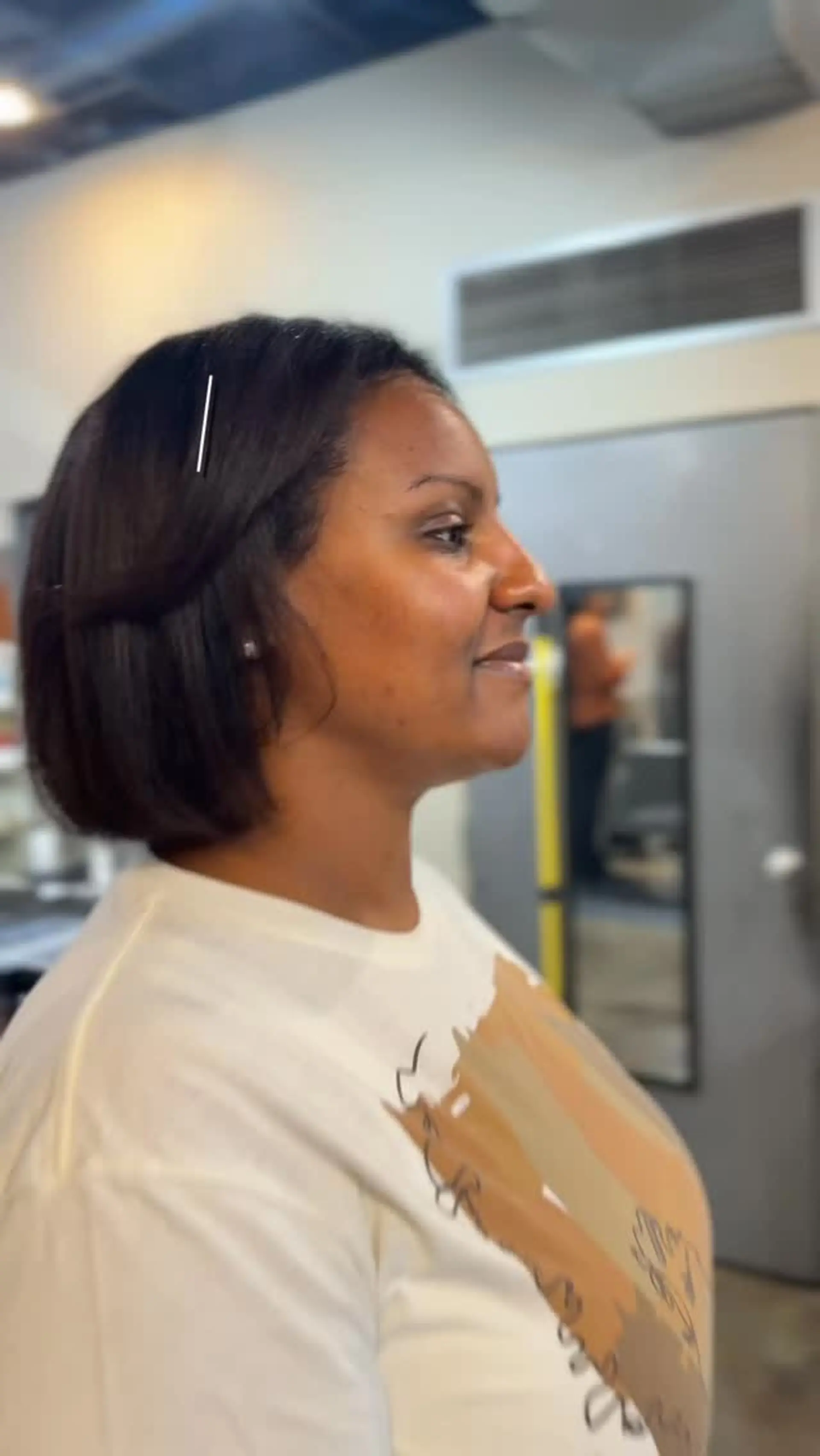 A sleek, chin-length straight bob achieved with a smooth silk press and subtle inward-curled ends. 1