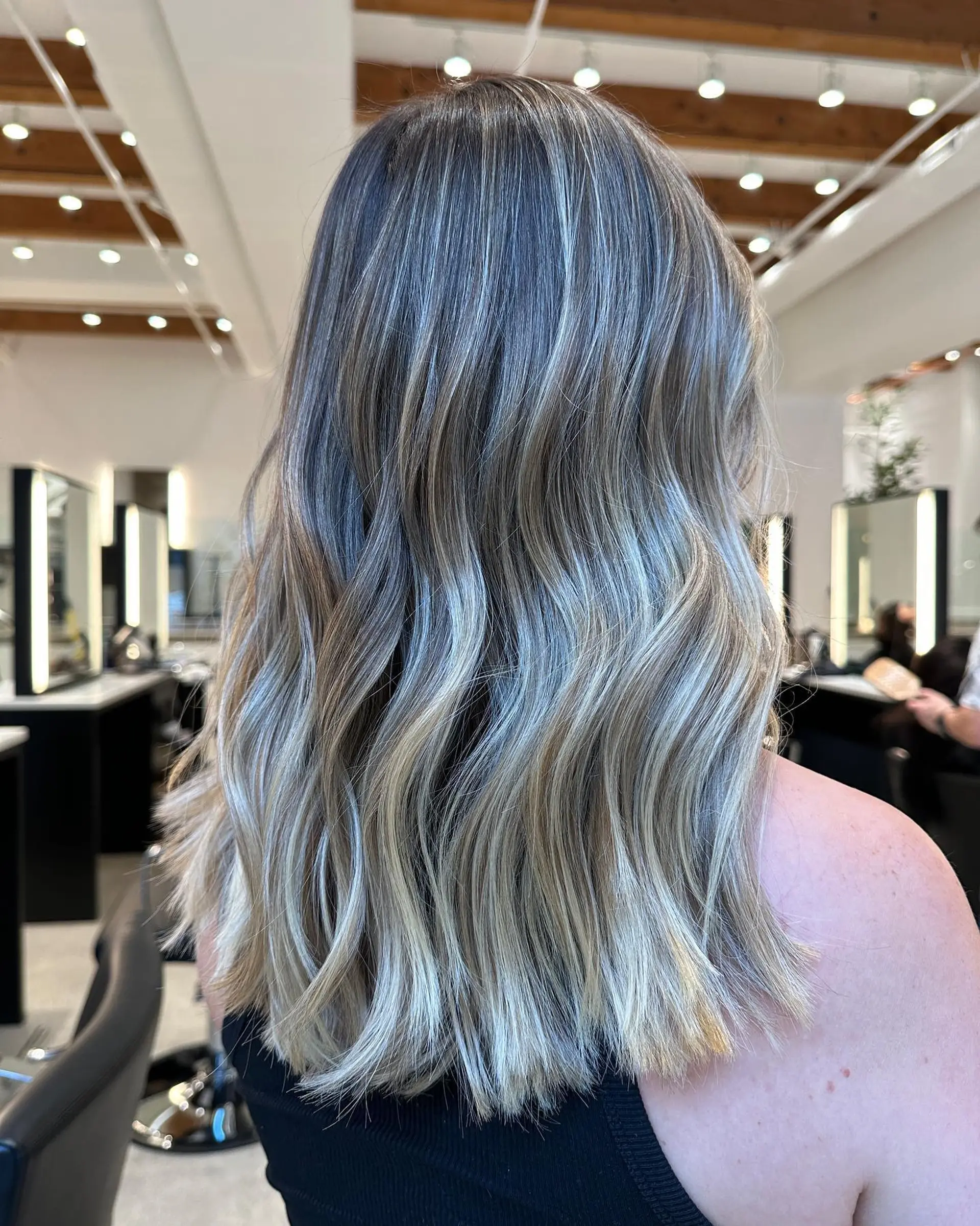 Long wavy hair with a dimensional ash blonde balayage. 1