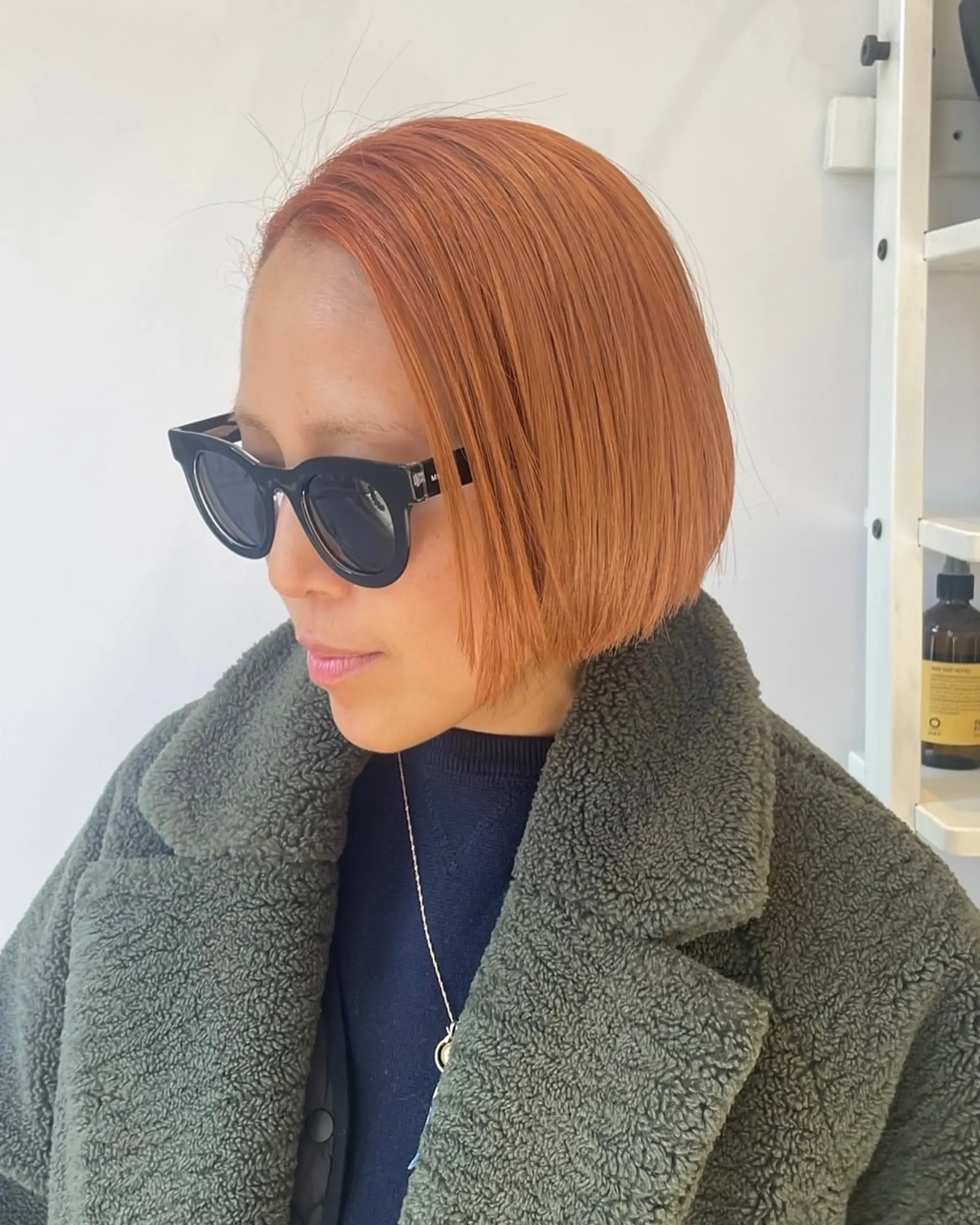 A sleek, blunt bob cut in a vibrant copper tone. 1