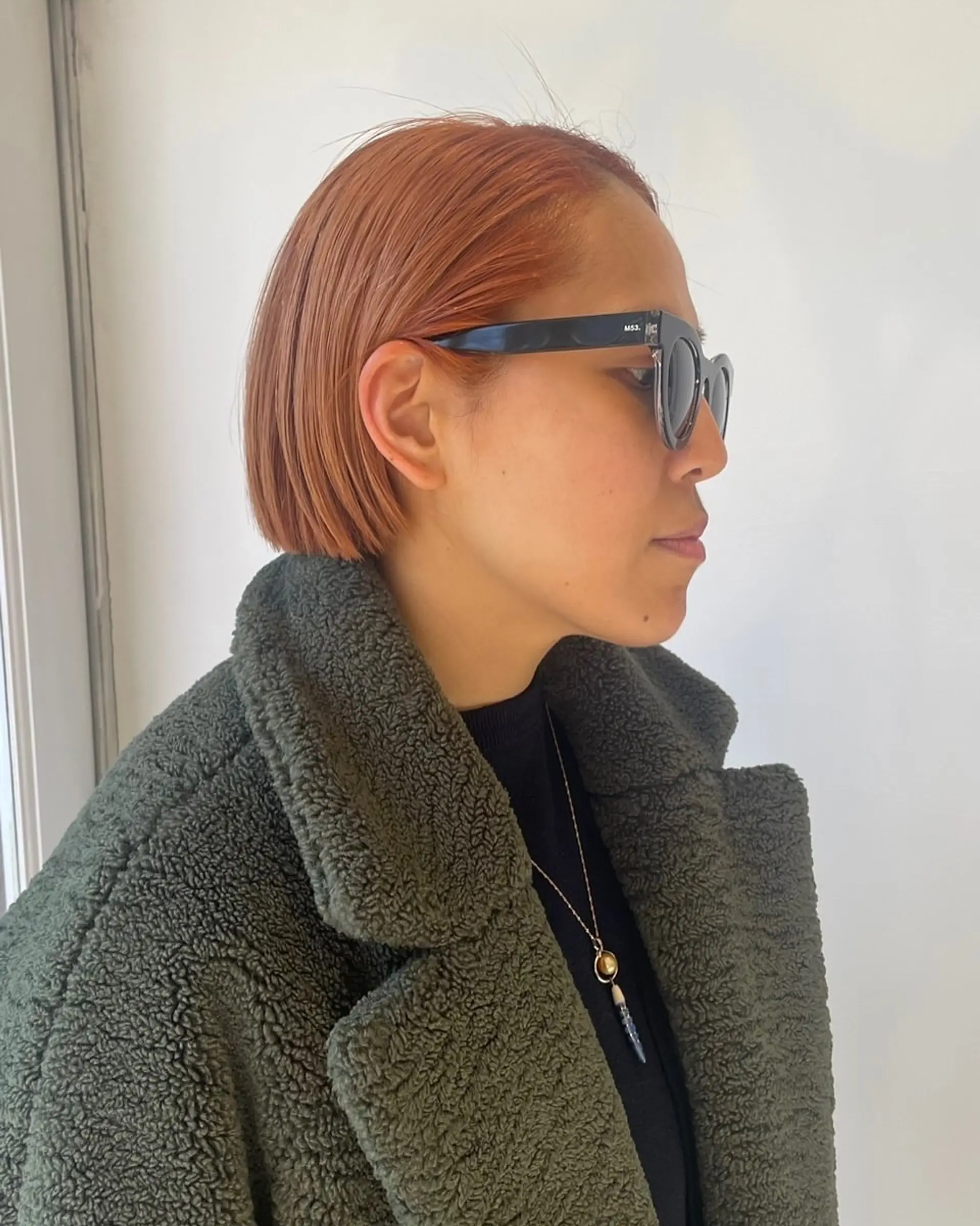 A sleek, blunt bob cut in a vibrant copper tone. 3