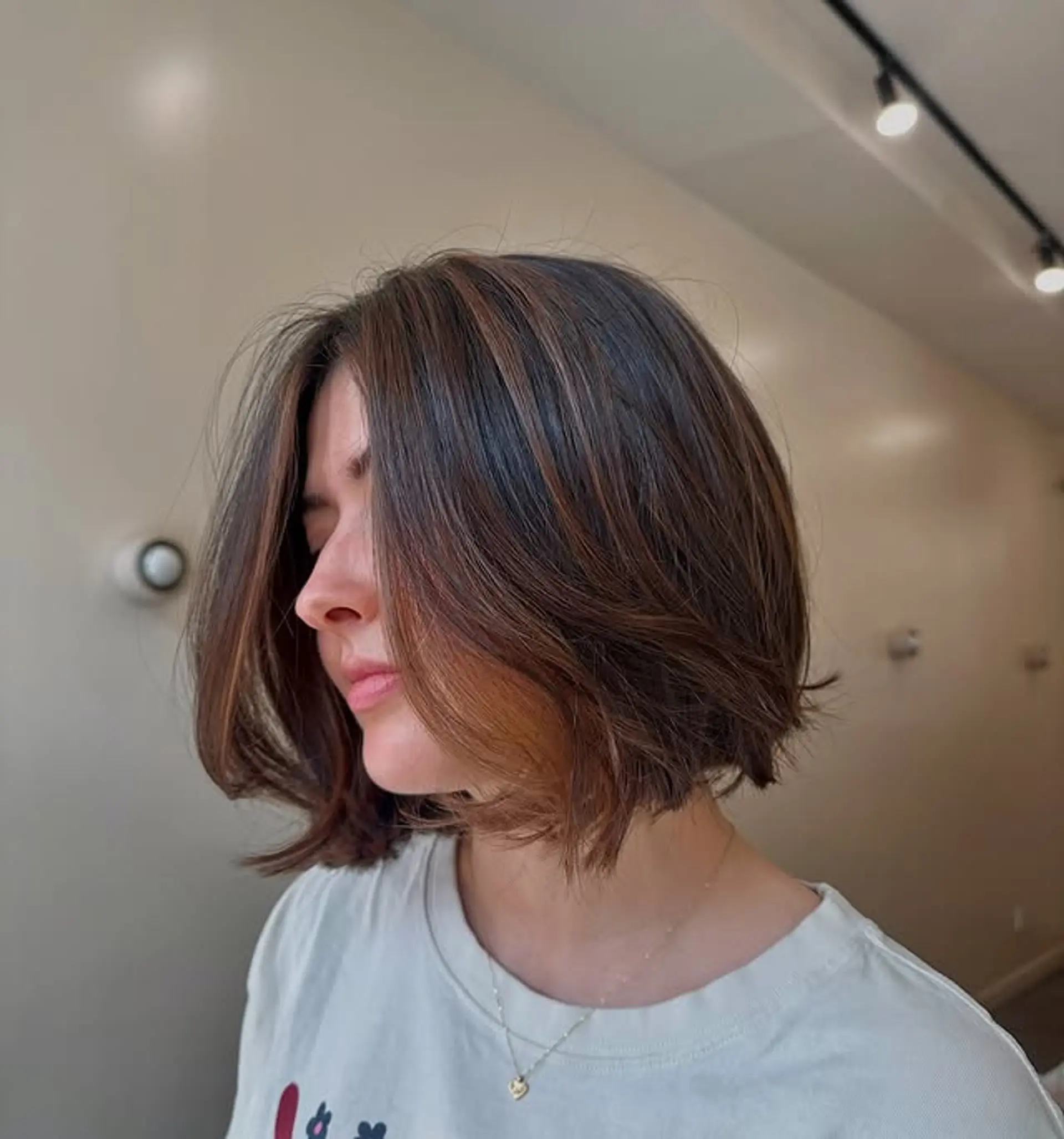 A short, layered bob with face-framing highlights. 1