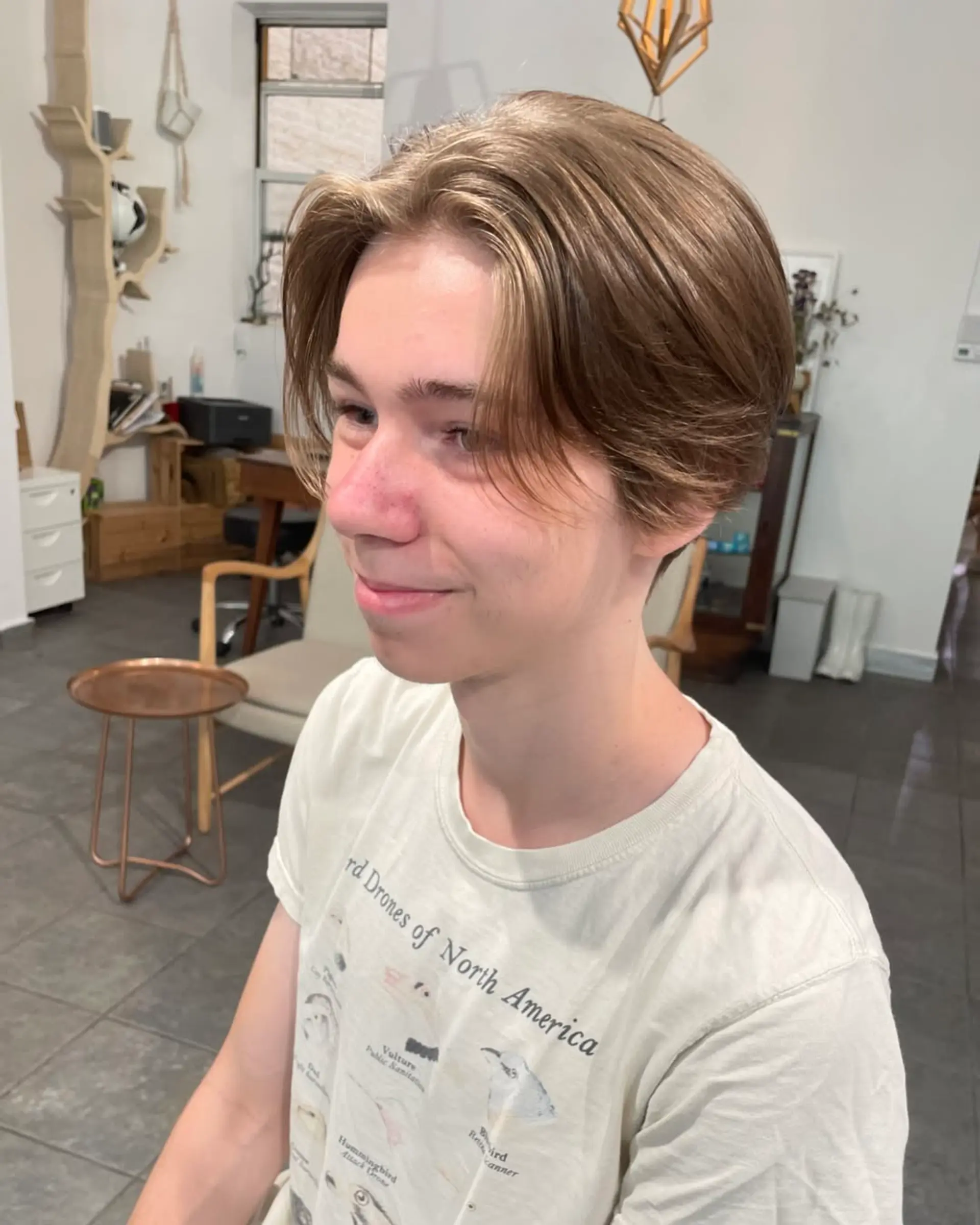 A layered, medium-length haircut with a center part and textured ends. 1