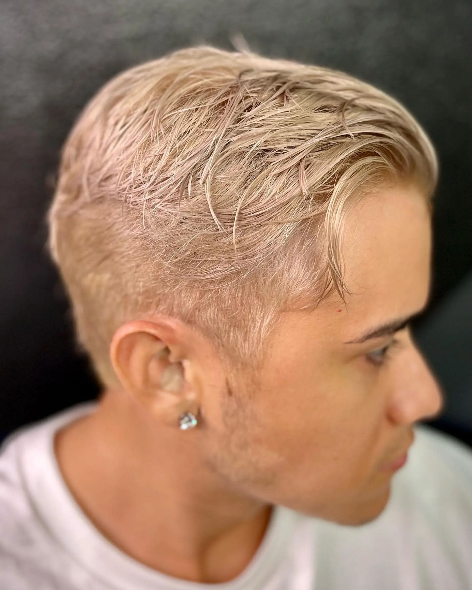 A stylish short haircut with short back and sides and a textured top. 1