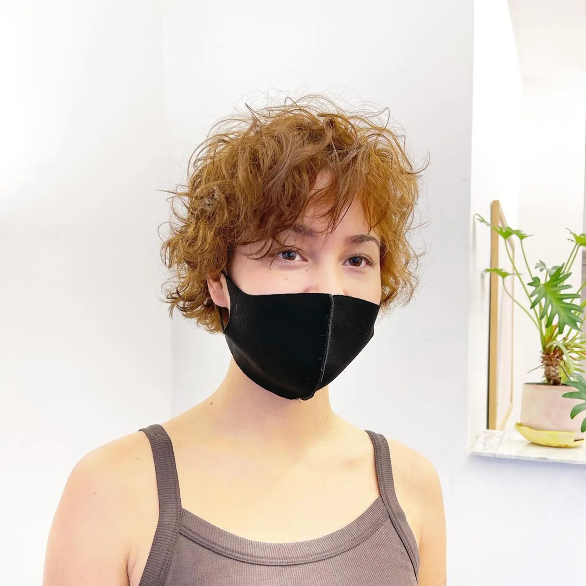 Short, curly hair with rich copper and auburn shades. Layered and textured curls create volume and a tousled, windswept look by Takeo. 1