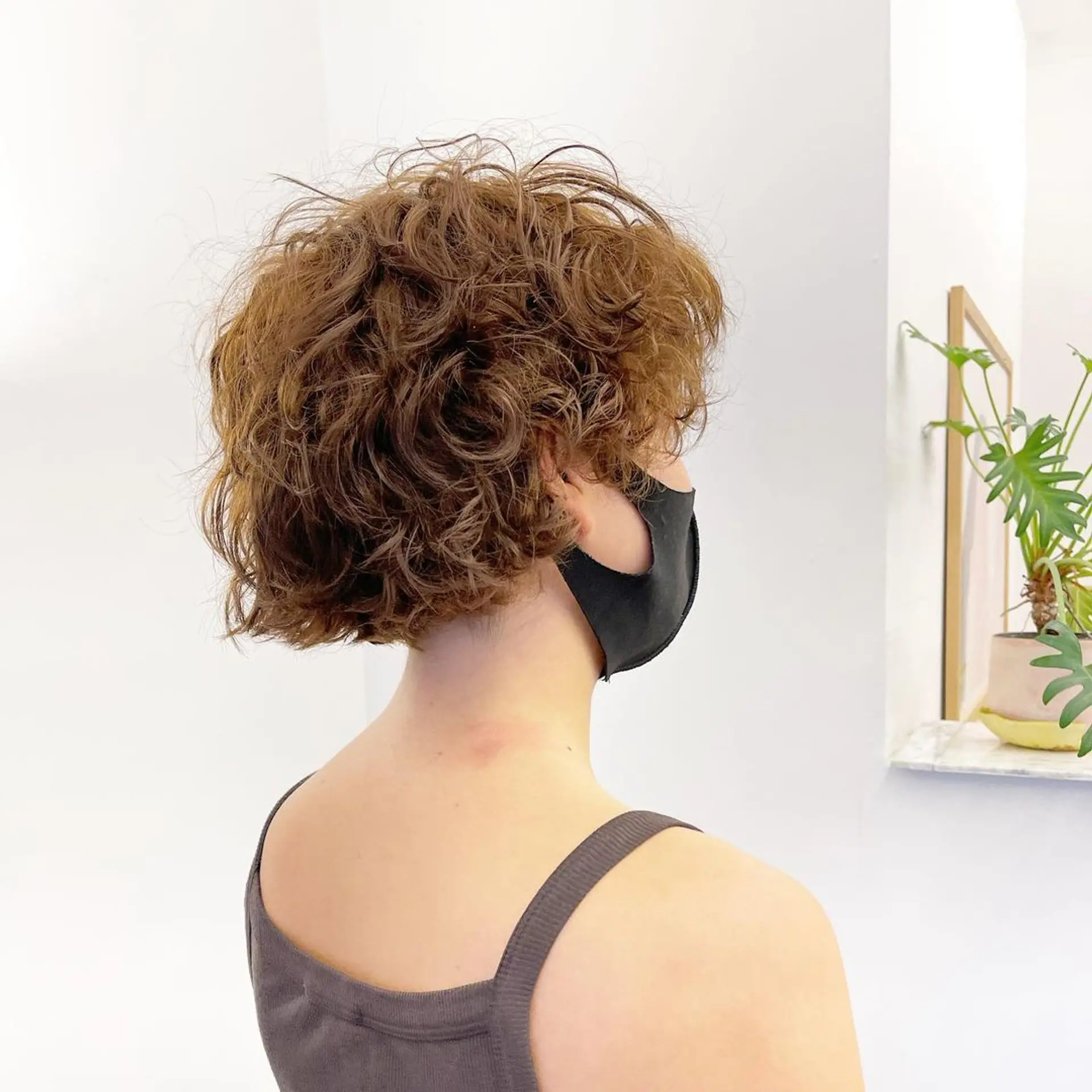 Short, curly hair with rich copper and auburn shades. Layered and textured curls create volume and a tousled, windswept look by Takeo. 2