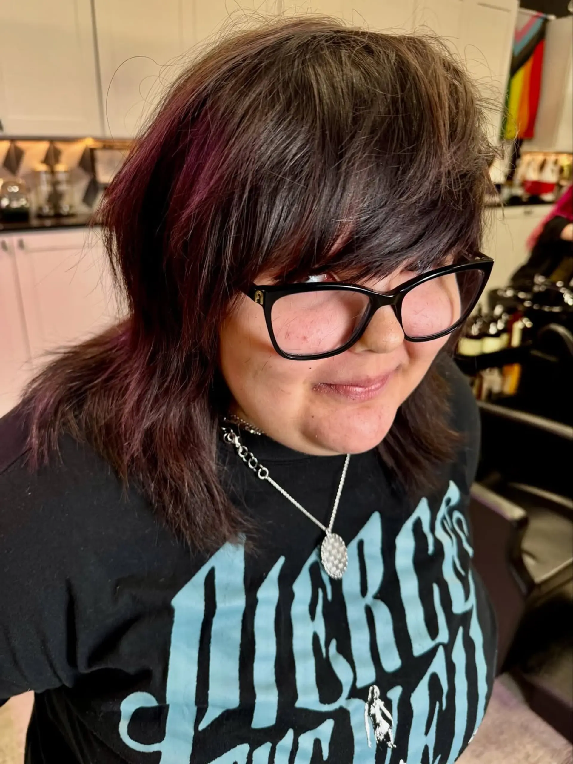 A trendy, medium-length layered shag haircut featuring a choppy, textured finish and full, wispy bangs that frame the face, giving off a relaxed yet edgy vibe. 1