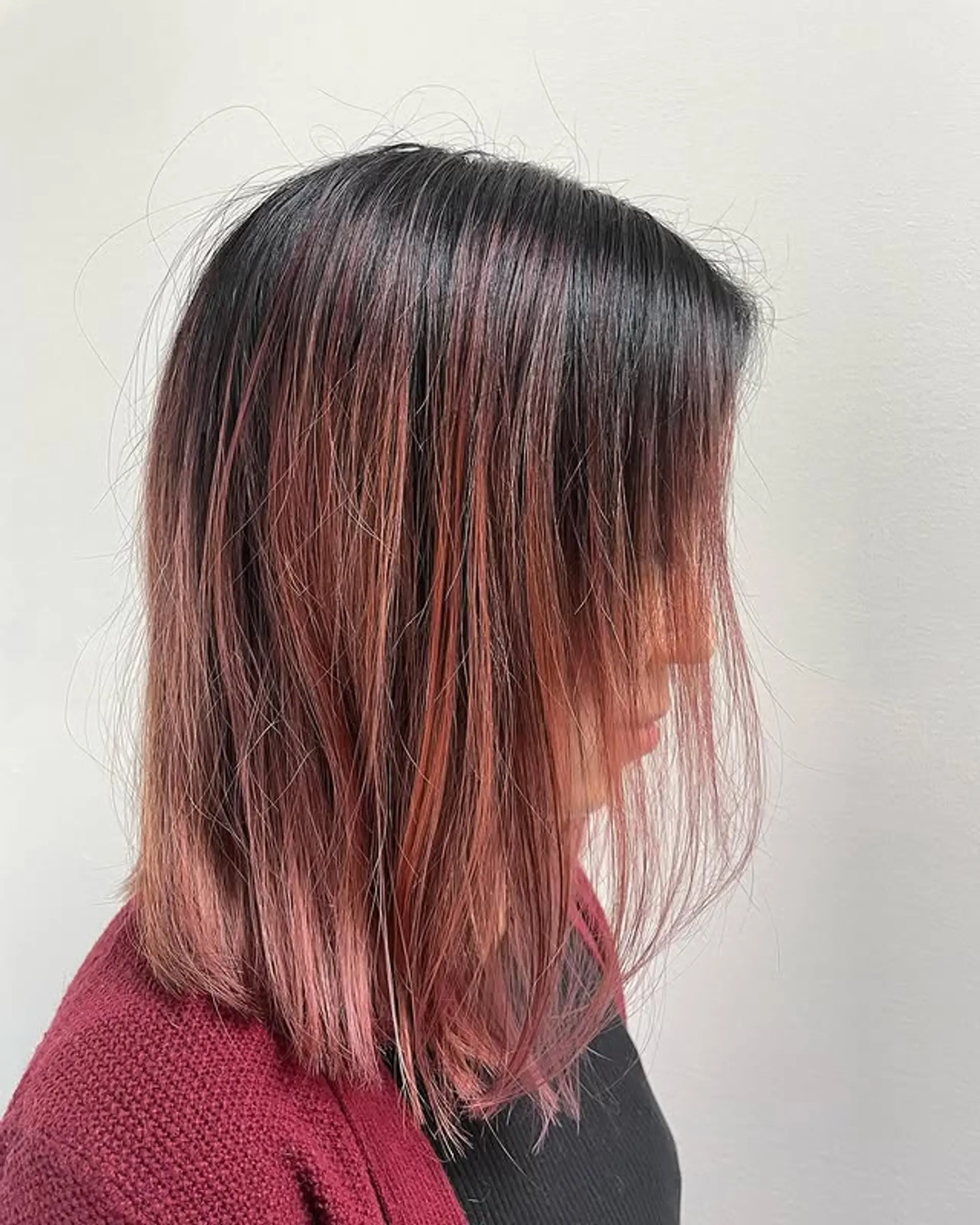 A stunning ombre that blends dark roots into rose gold ends, creating a chic and modern look. 1