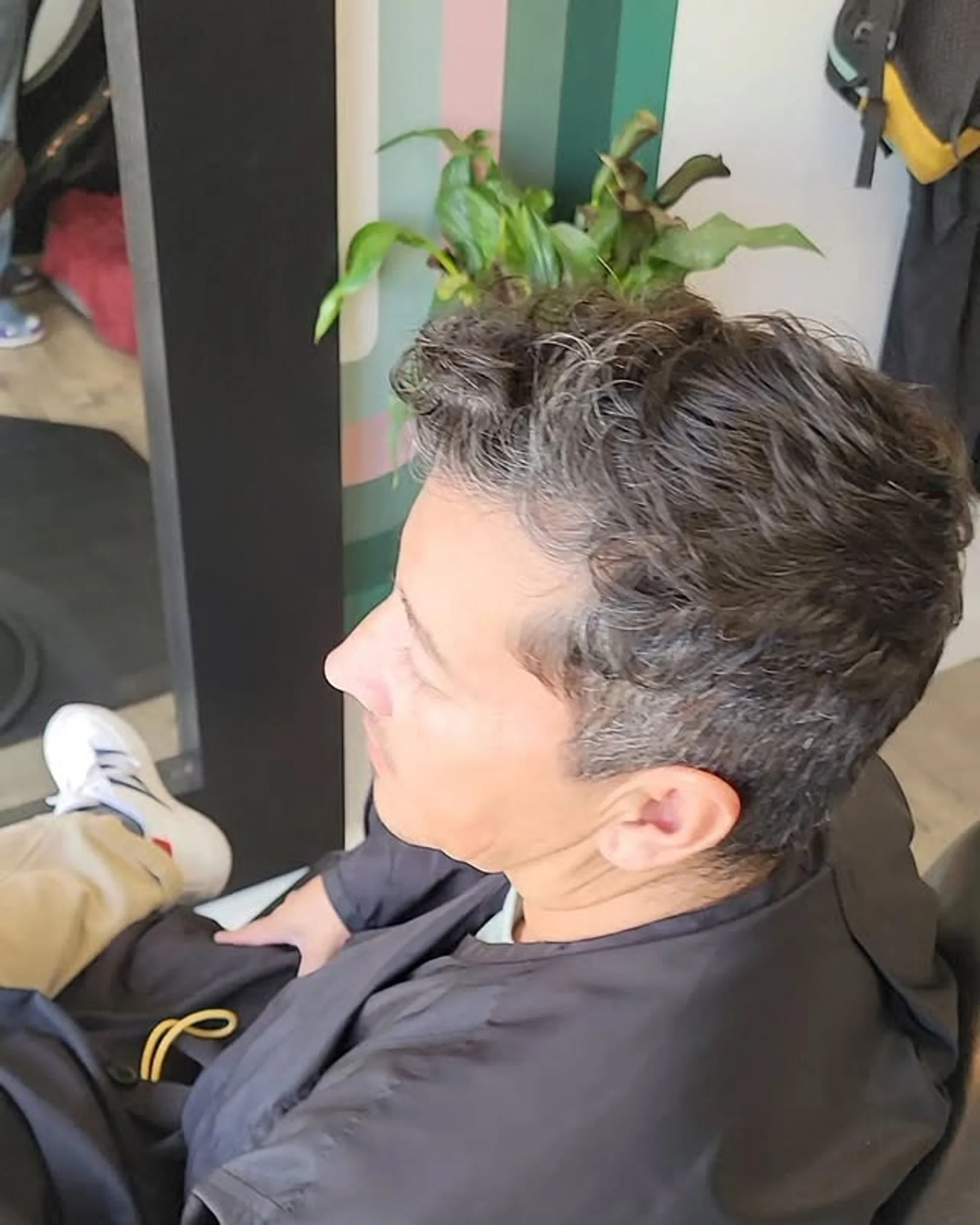 A short haircut with a fade on the sides and a defined curly top. - Preview 3