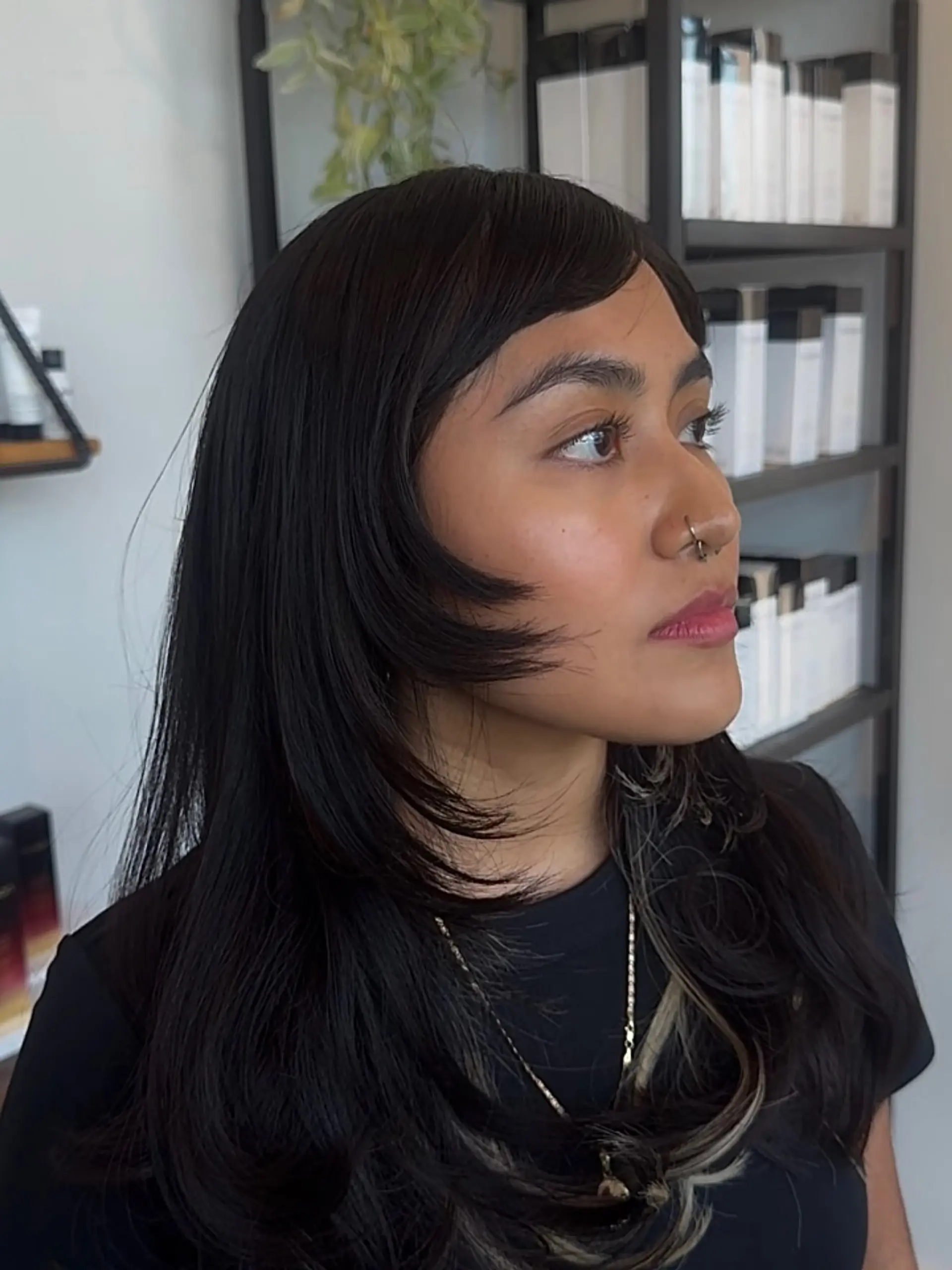 Long black hair featuring dramatic face-framing layers, side-swept bangs, and subtle blonde peekaboo highlights. 1