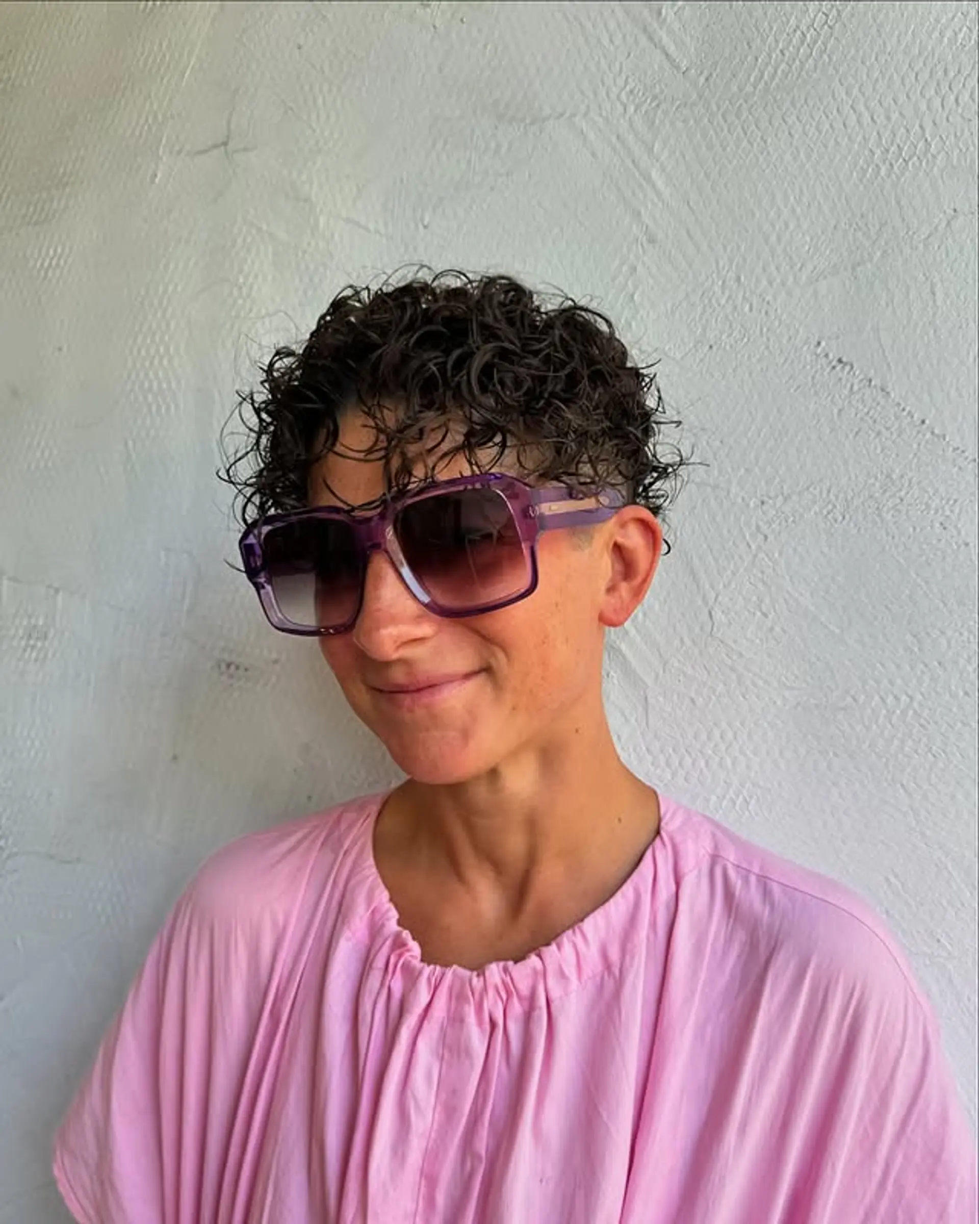 A stylish, very short pixie cut designed for curly hair, emphasizing natural texture and ease of styling. 1