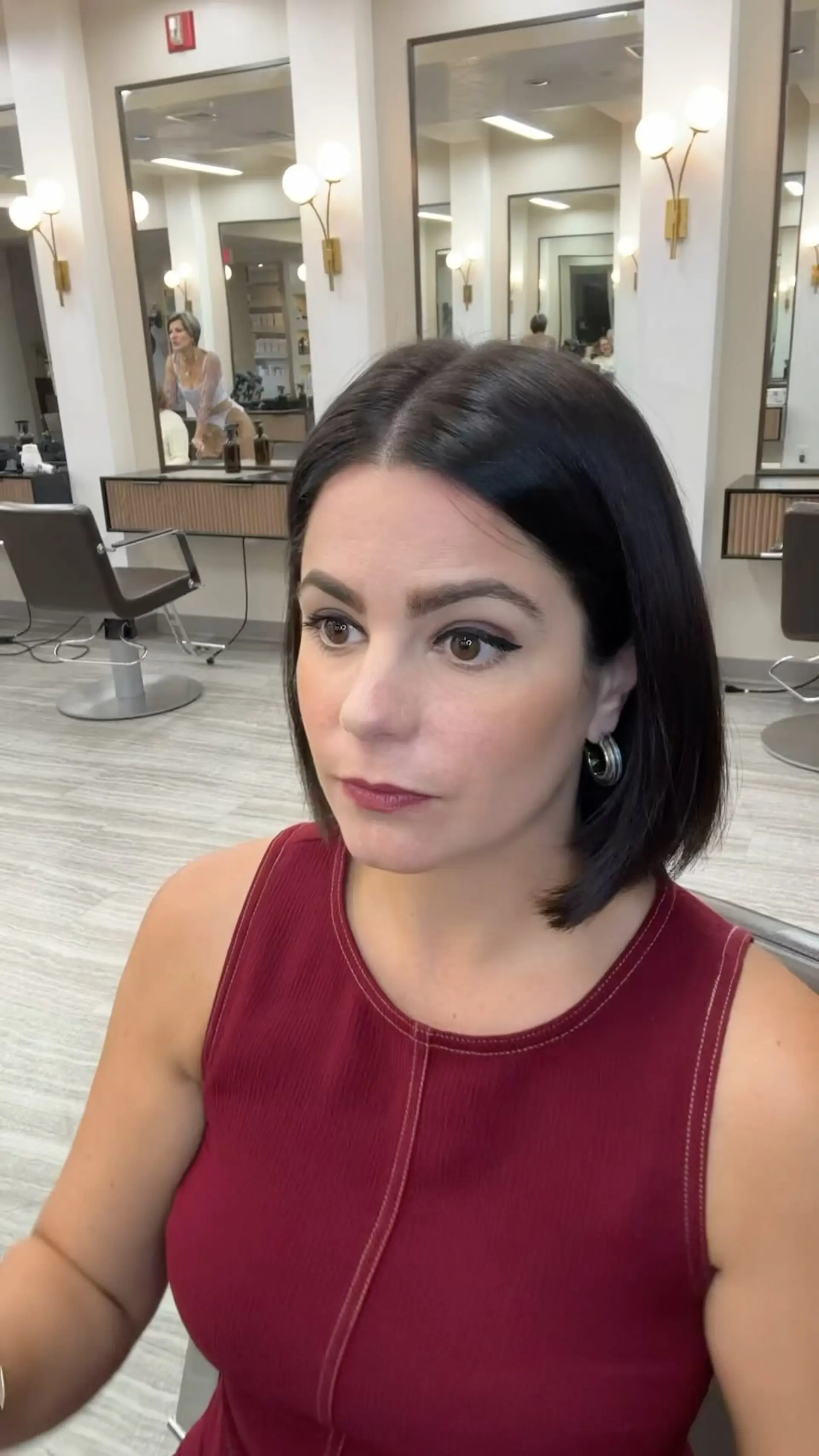A sleek, chin-length blunt bob styled straight with a crisp center part in deep black. 1
