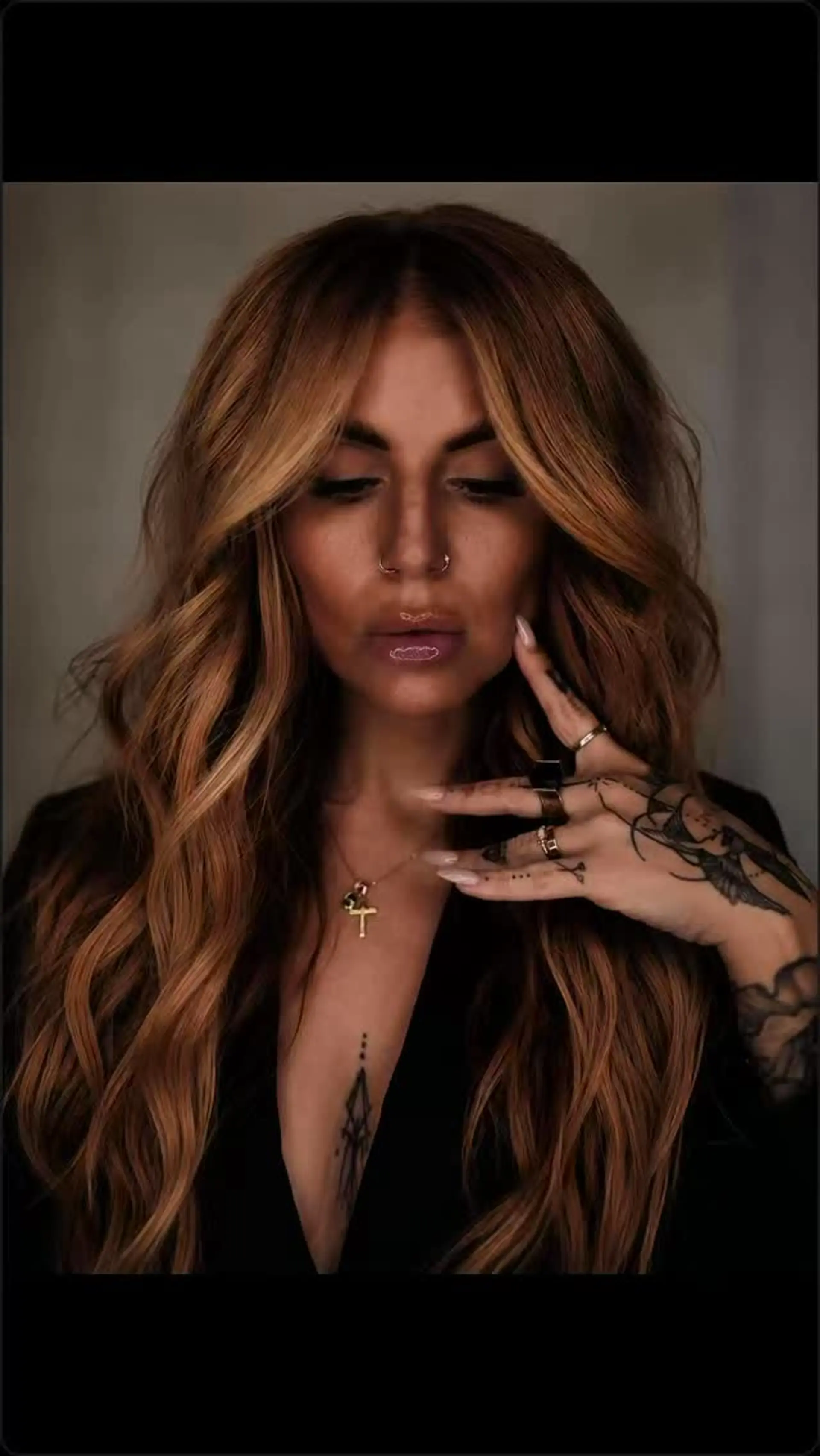Long warm caramel and honey balayage styled with soft, voluminous waves and bright face-framing pieces. 1