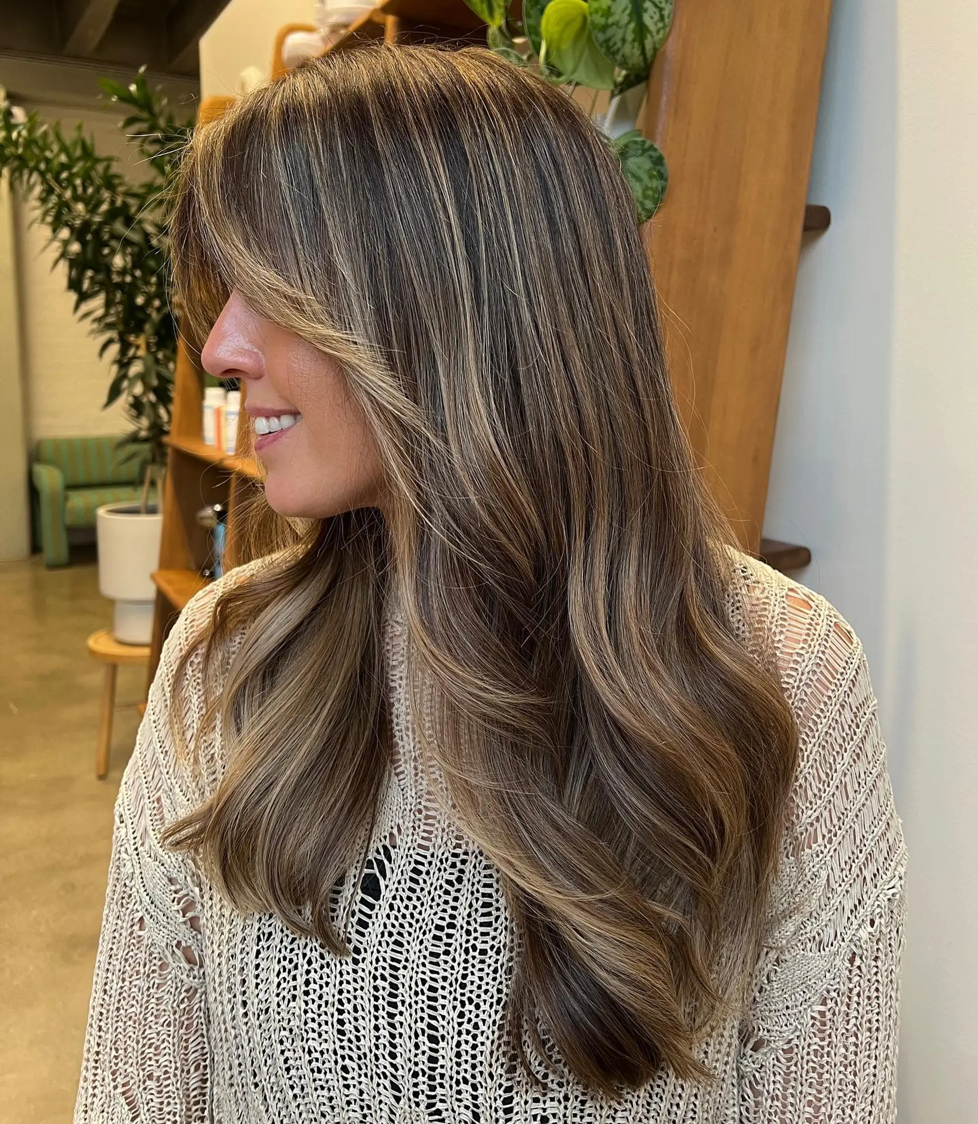 Long, wavy hair with face-framing layers and caramel balayage highlights. 1