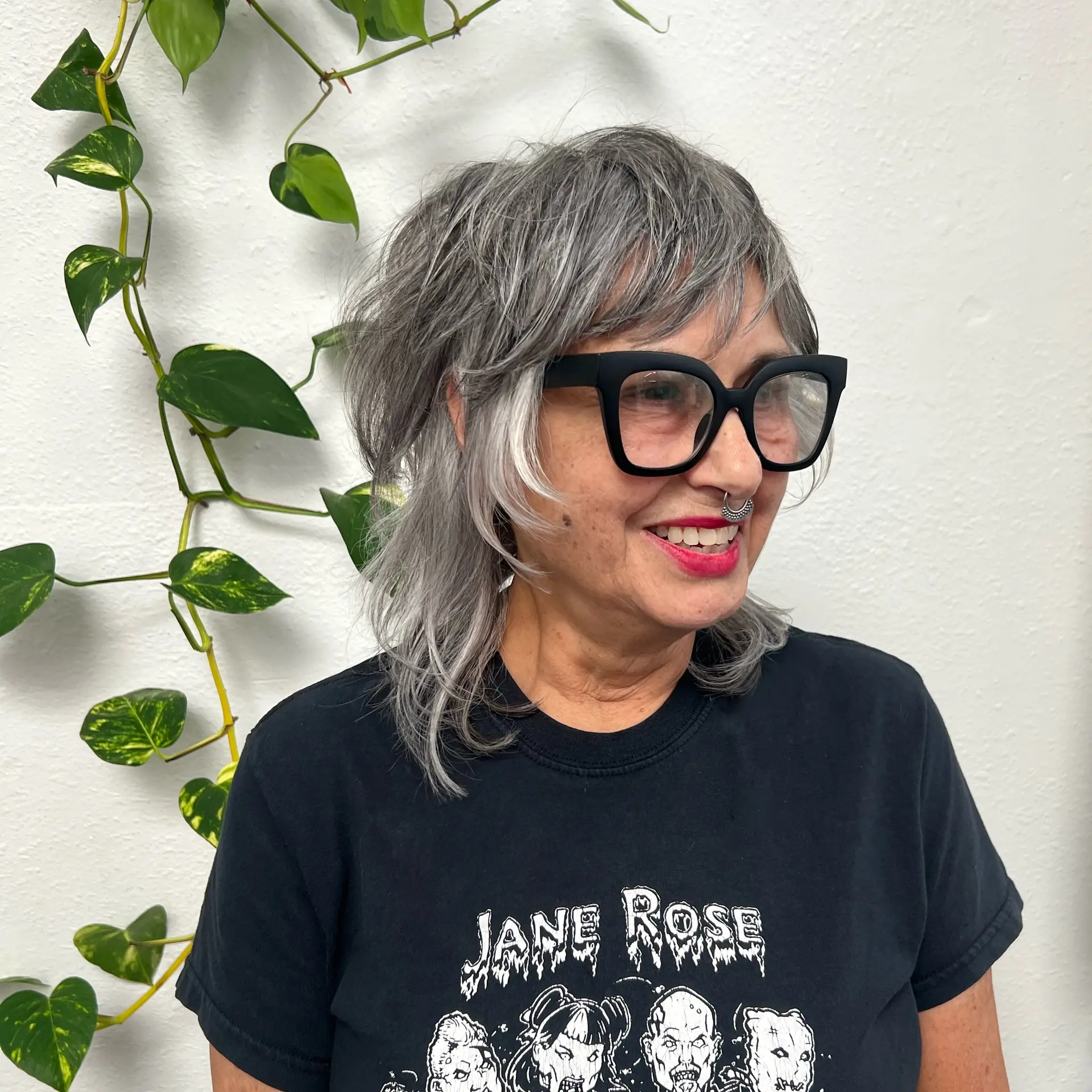 A textured silver shag haircut with curtain bangs and face-framing layers. 1
