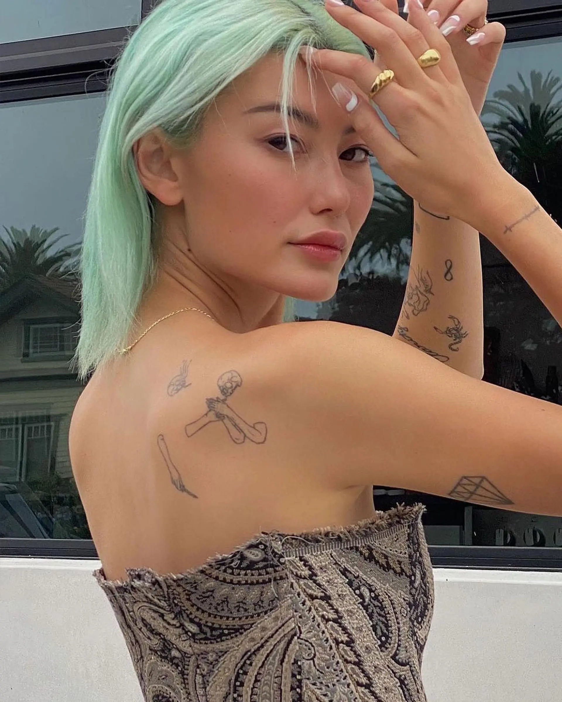 A chic, straight bob cut dyed in pastel mint green, offering a sleek and modern look. 1