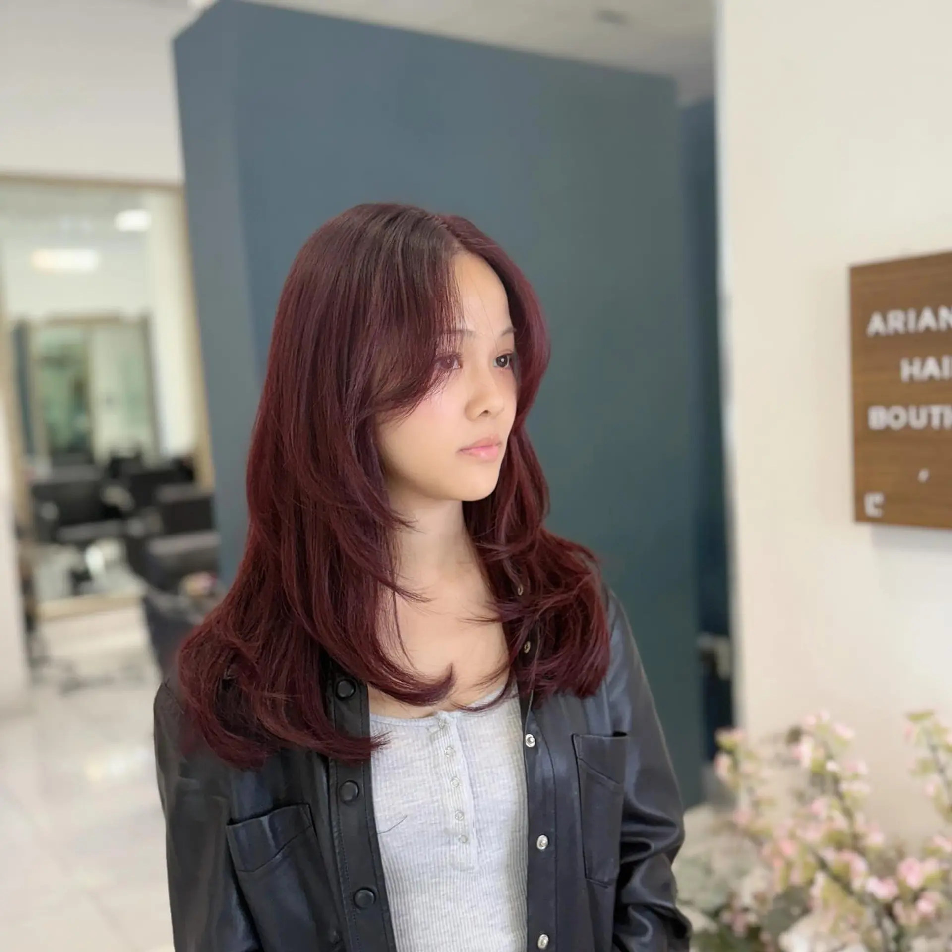 A long, layered cut featuring soft curtain bangs that frame the face and smooth styling with flipped-in ends. 1