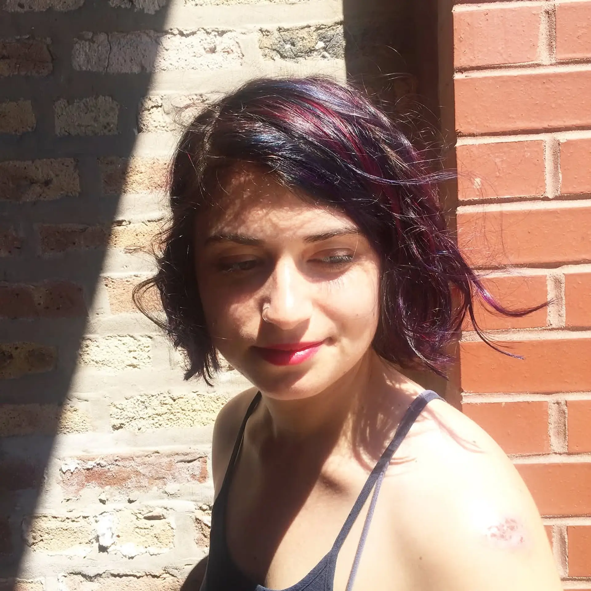 A chic, short wavy bob with layered highlights in bold jewel tones. 1