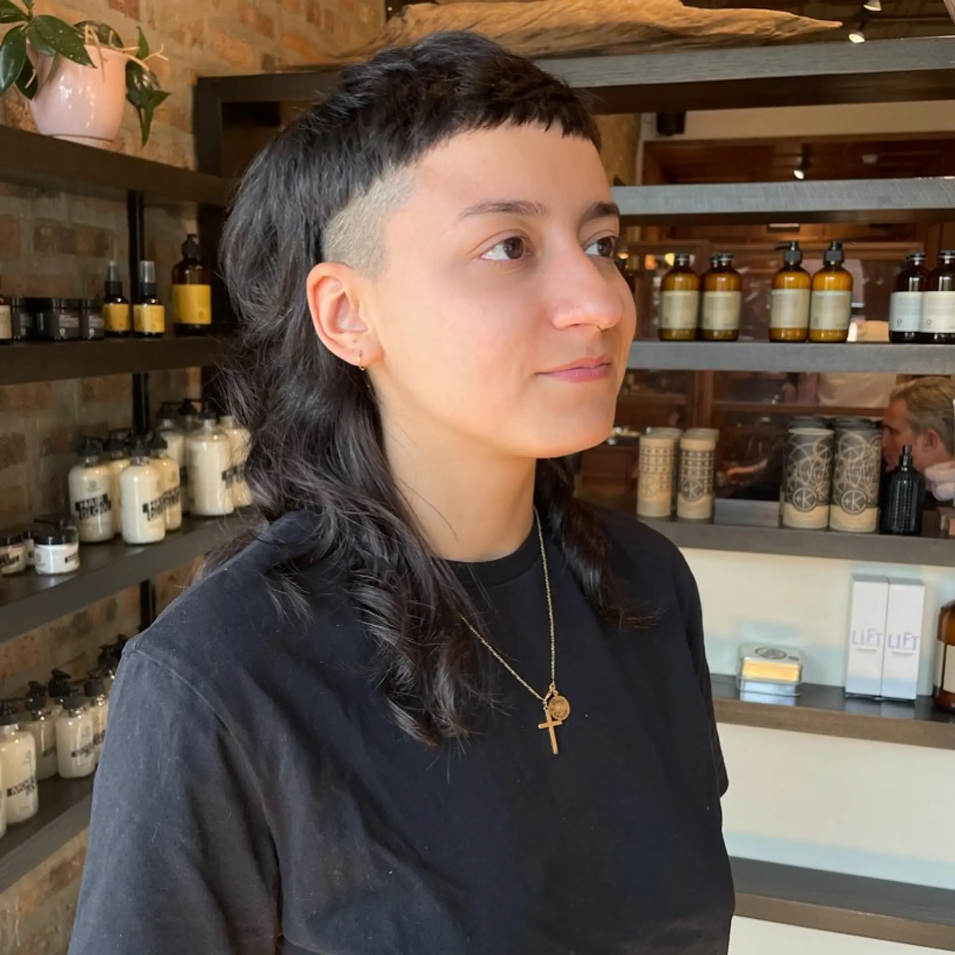 A modern mullet with shaved sides and short, blunt baby bangs. 1