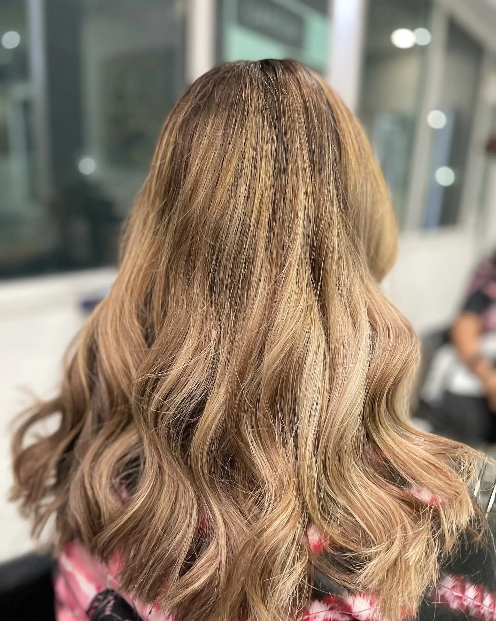 Long wavy hair with a golden bronde balayage. 1
