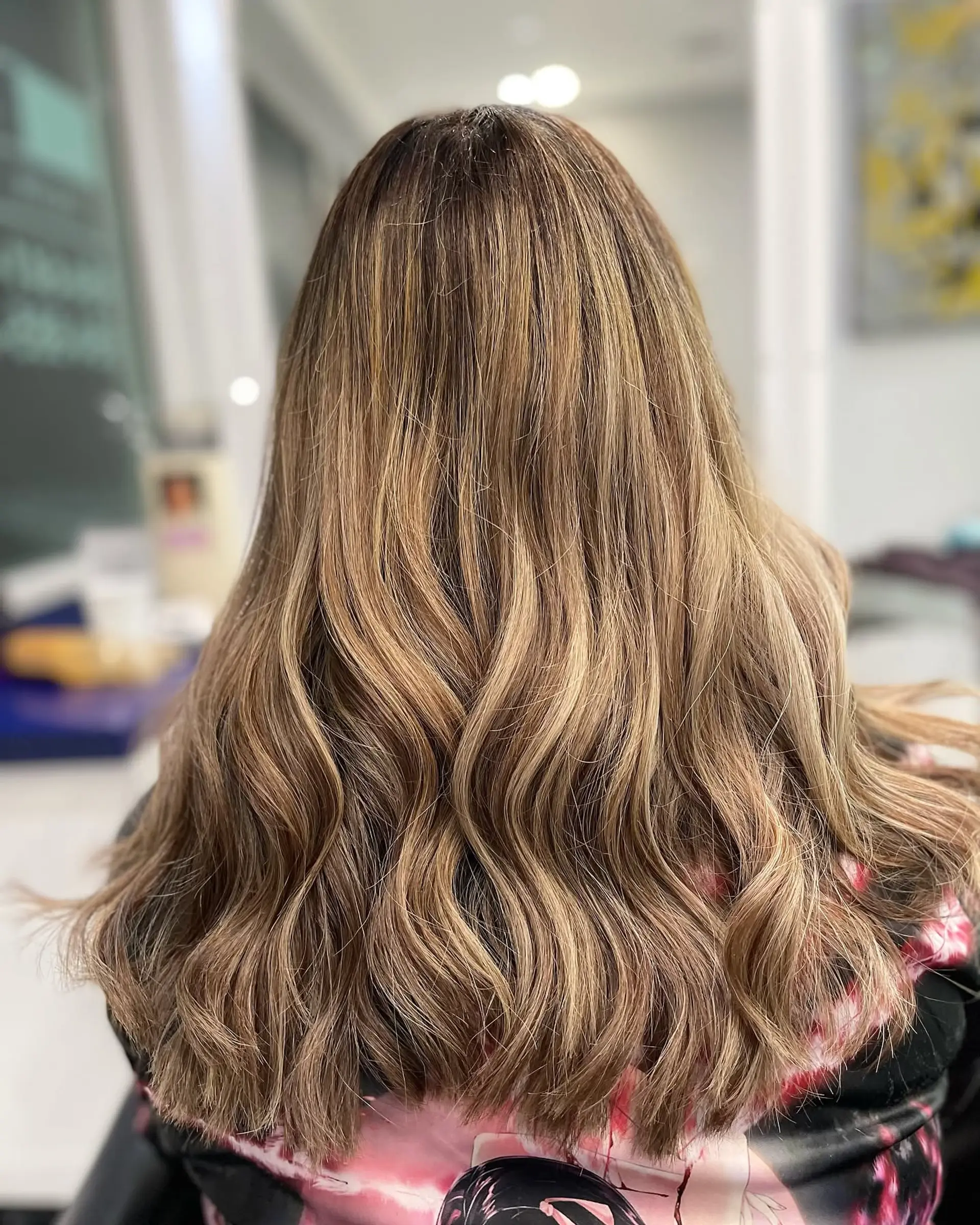 Long wavy hair with a golden bronde balayage. 2