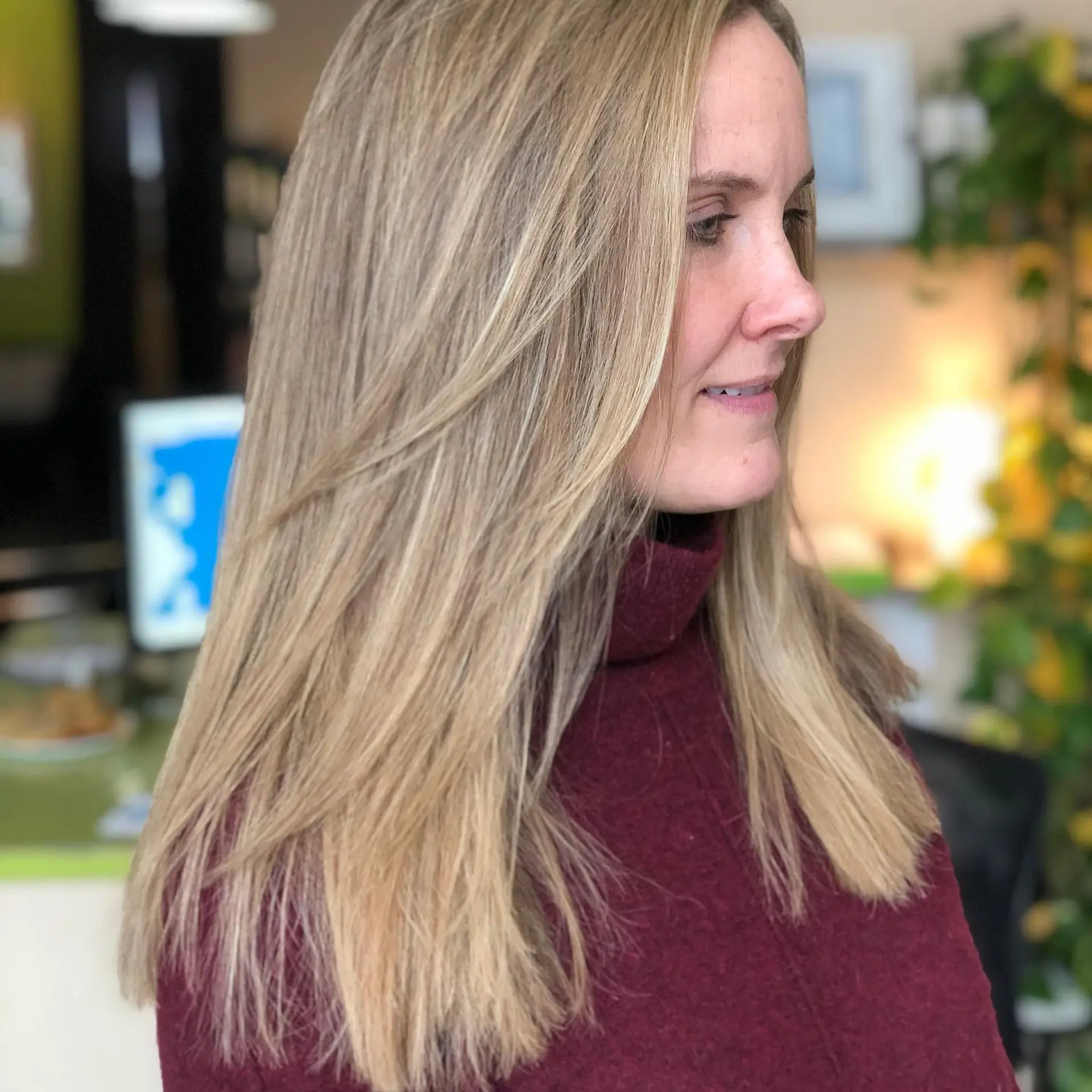 Straight, smooth long hair in a multi-tonal warm blonde shade with soft face-framing layers. 1