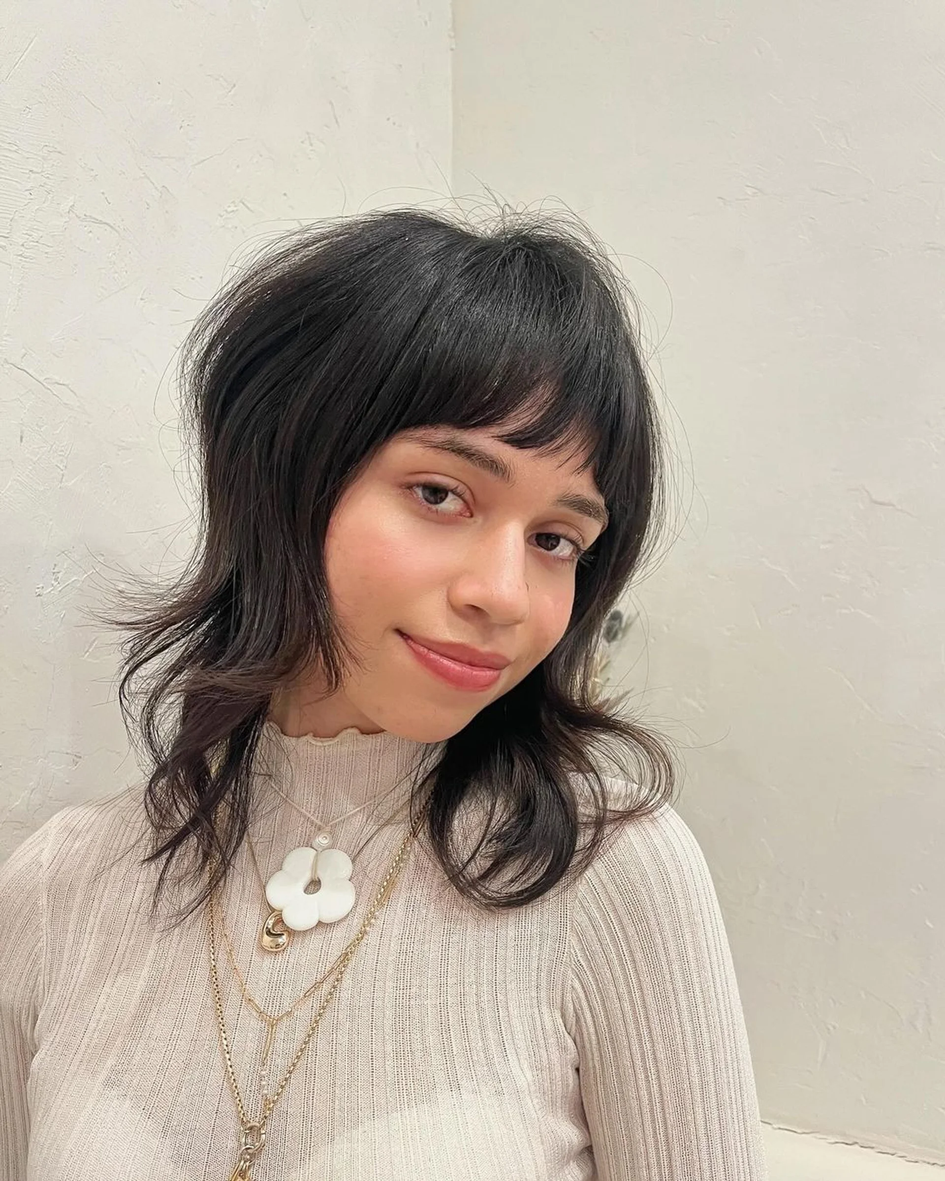 A layered, textured shag haircut with wispy bangs showcasing feathered softness. - Preview 3