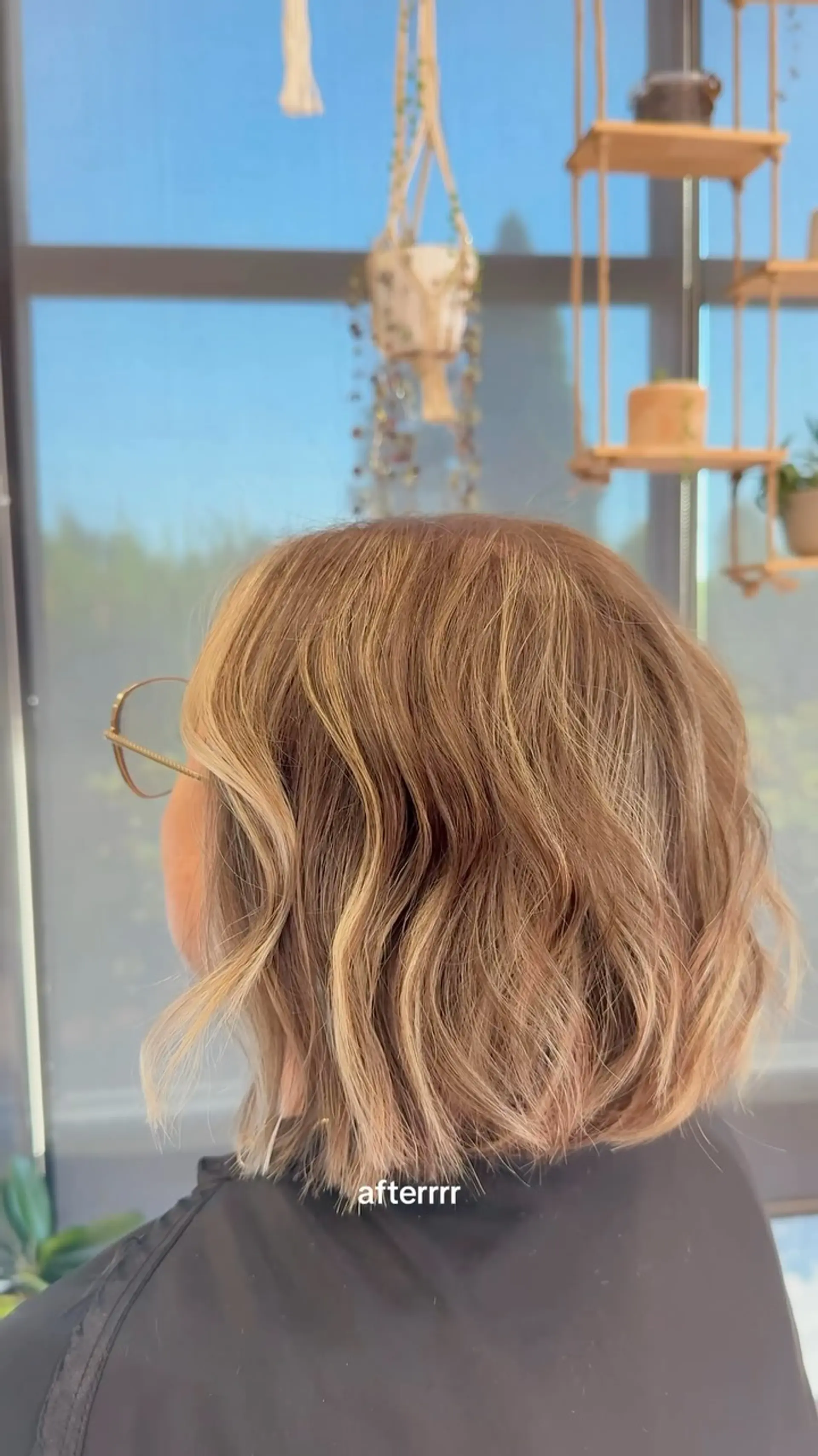 A blunt, textured neck-length bob styled with relaxed waves and dimensional blonde highlights. 1