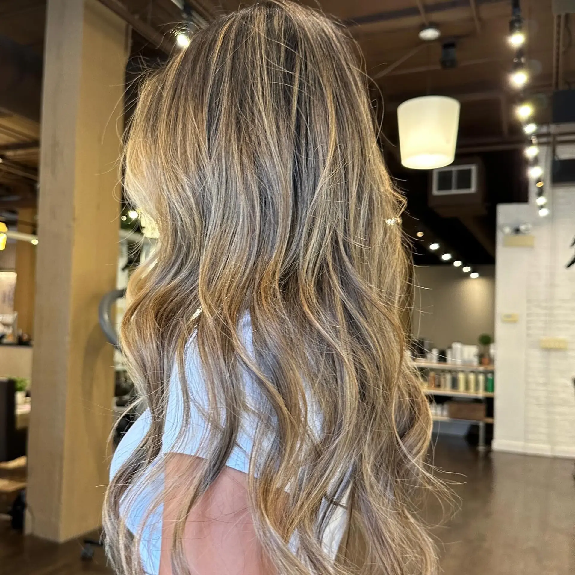 Long, wavy hair with a honey blonde balayage. 2