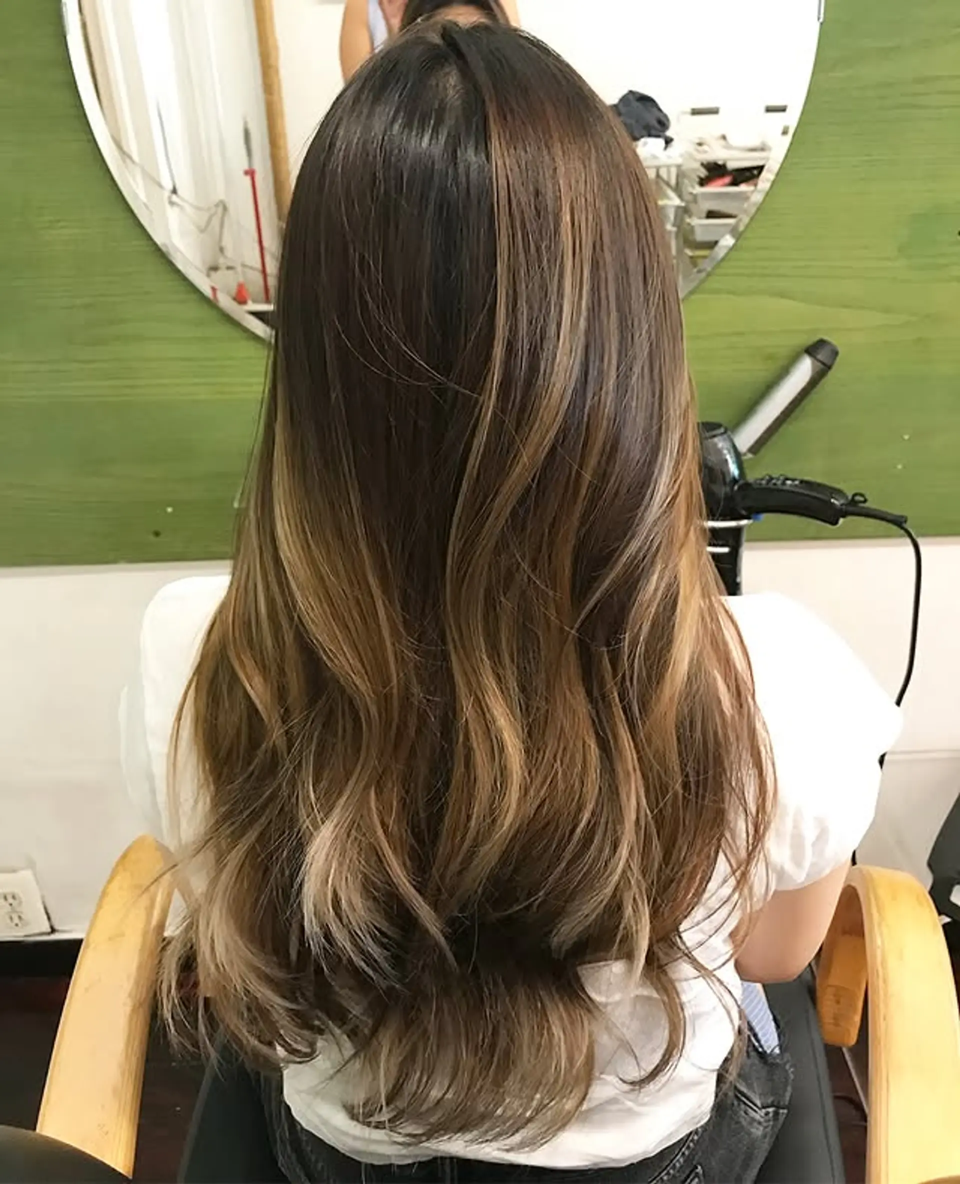 Long, wavy hair with a bronde balayage, creating a sunkissed effect. 1