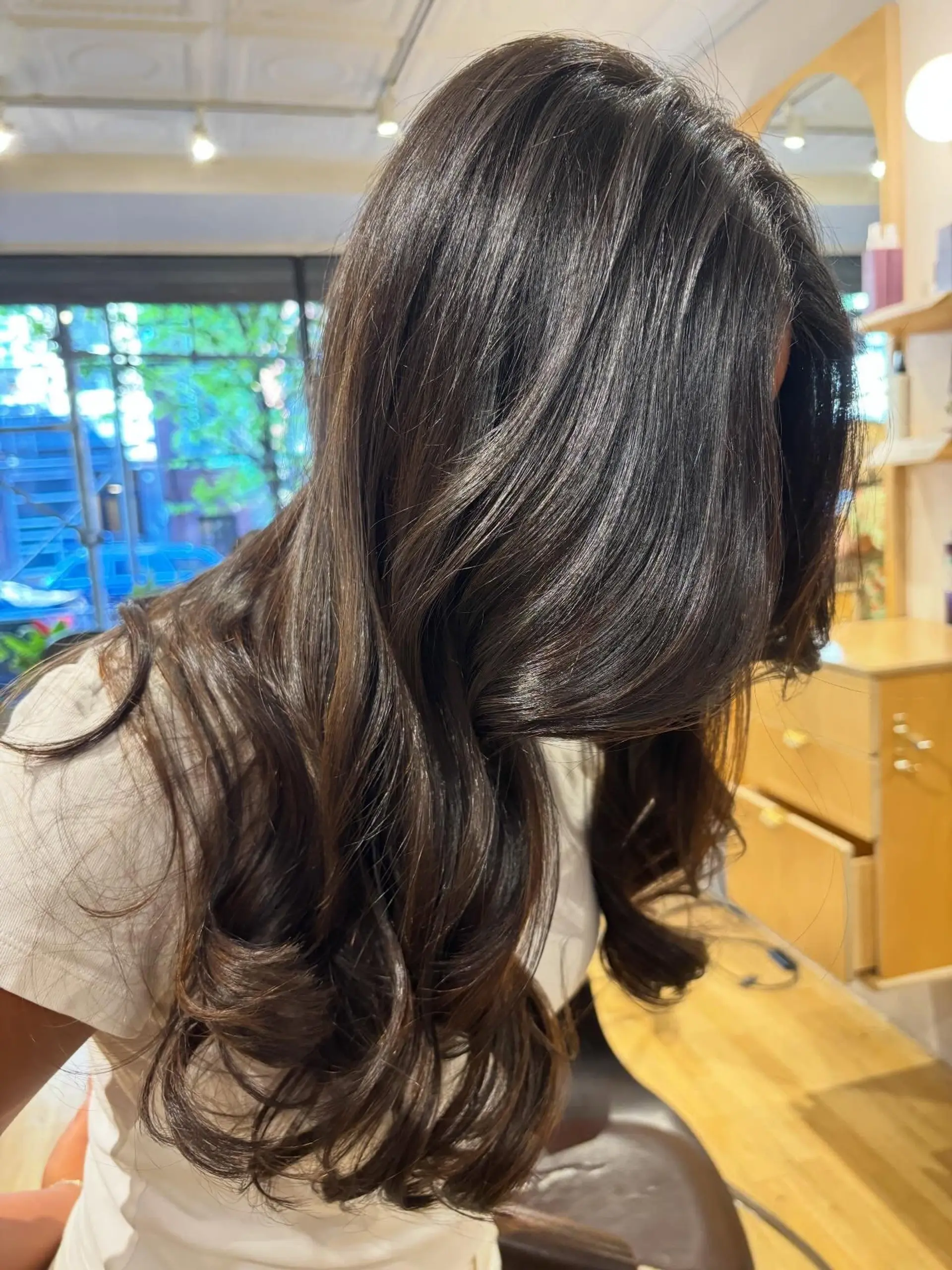 Long chocolate brown hair styled in glossy, voluminous blowout waves. 1