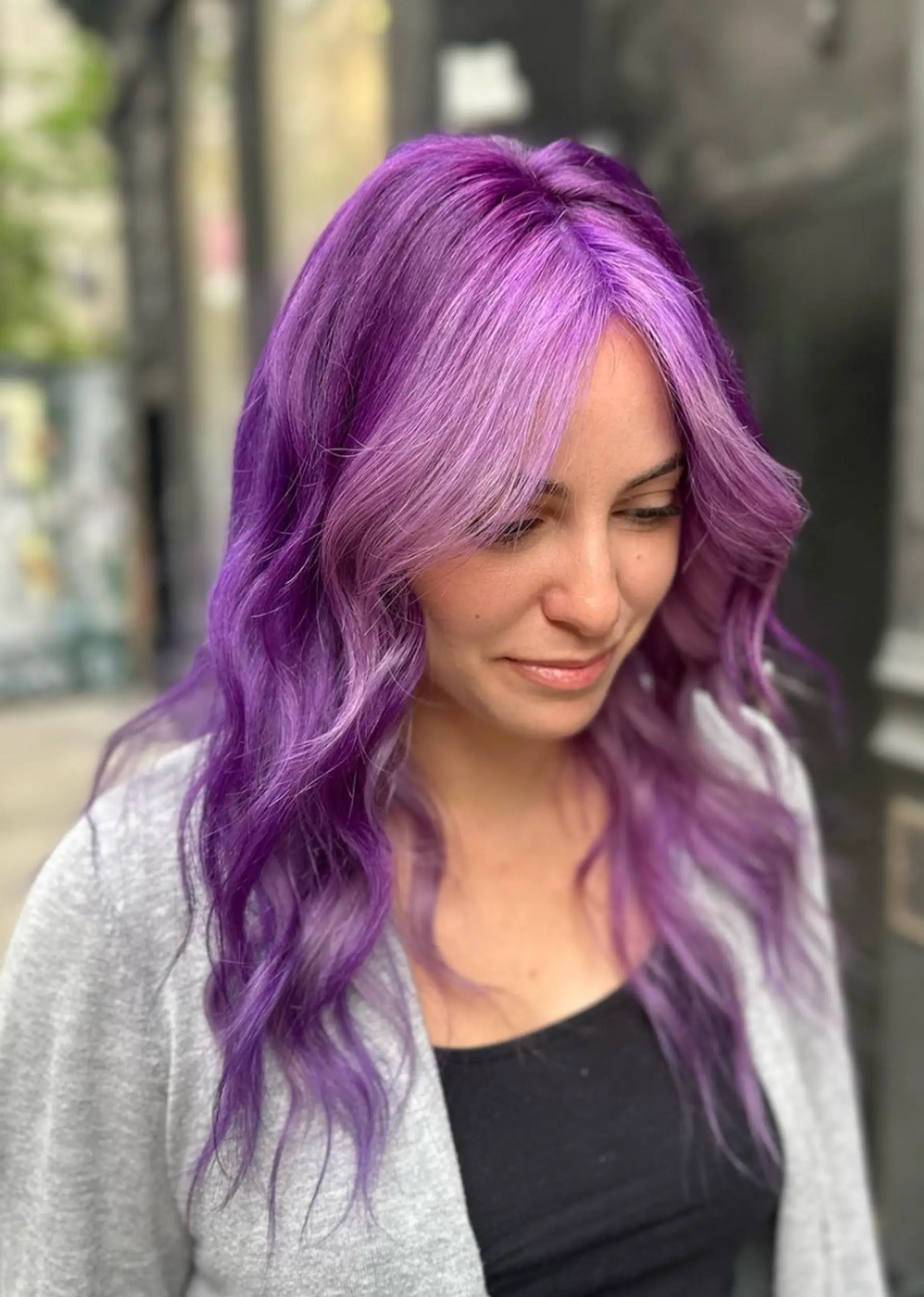 Long, wavy hair in lilac and purple shades with soft, face-framing layers and a shiny finish.

 1