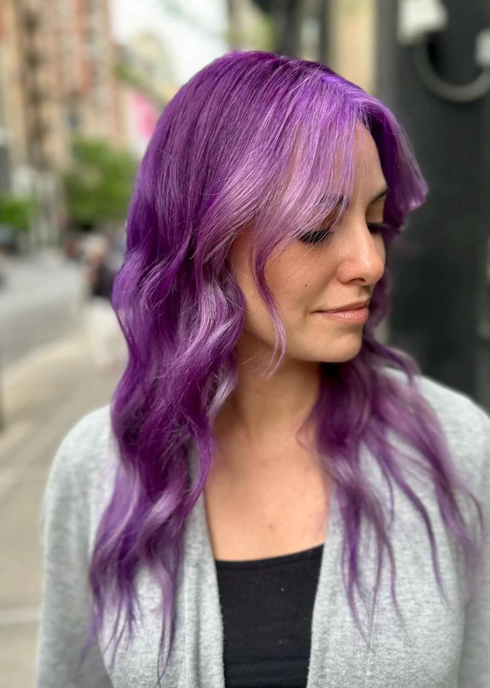 Long, wavy hair in lilac and purple shades with soft, face-framing layers and a shiny finish.

 2