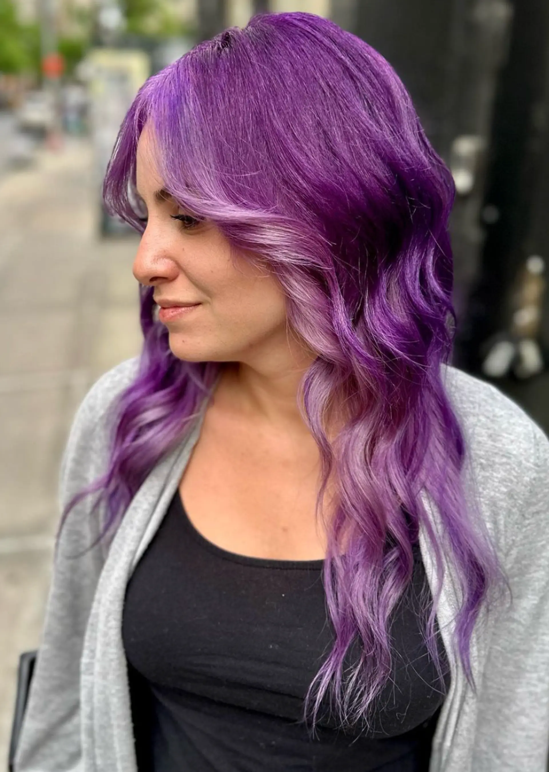 Long, wavy hair in lilac and purple shades with soft, face-framing layers and a shiny finish.

 3