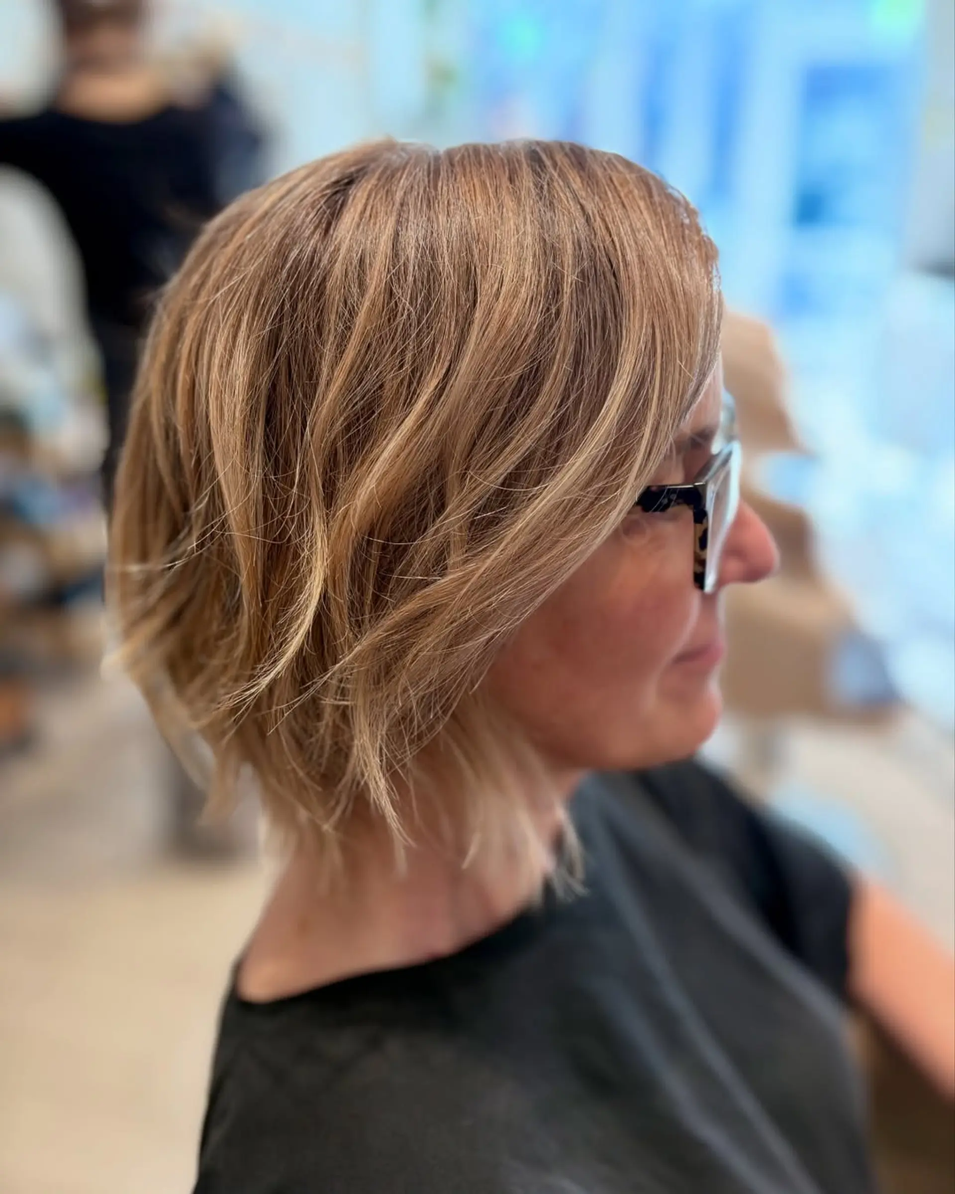 A short, layered bob with textured ends and subtle highlights. 1