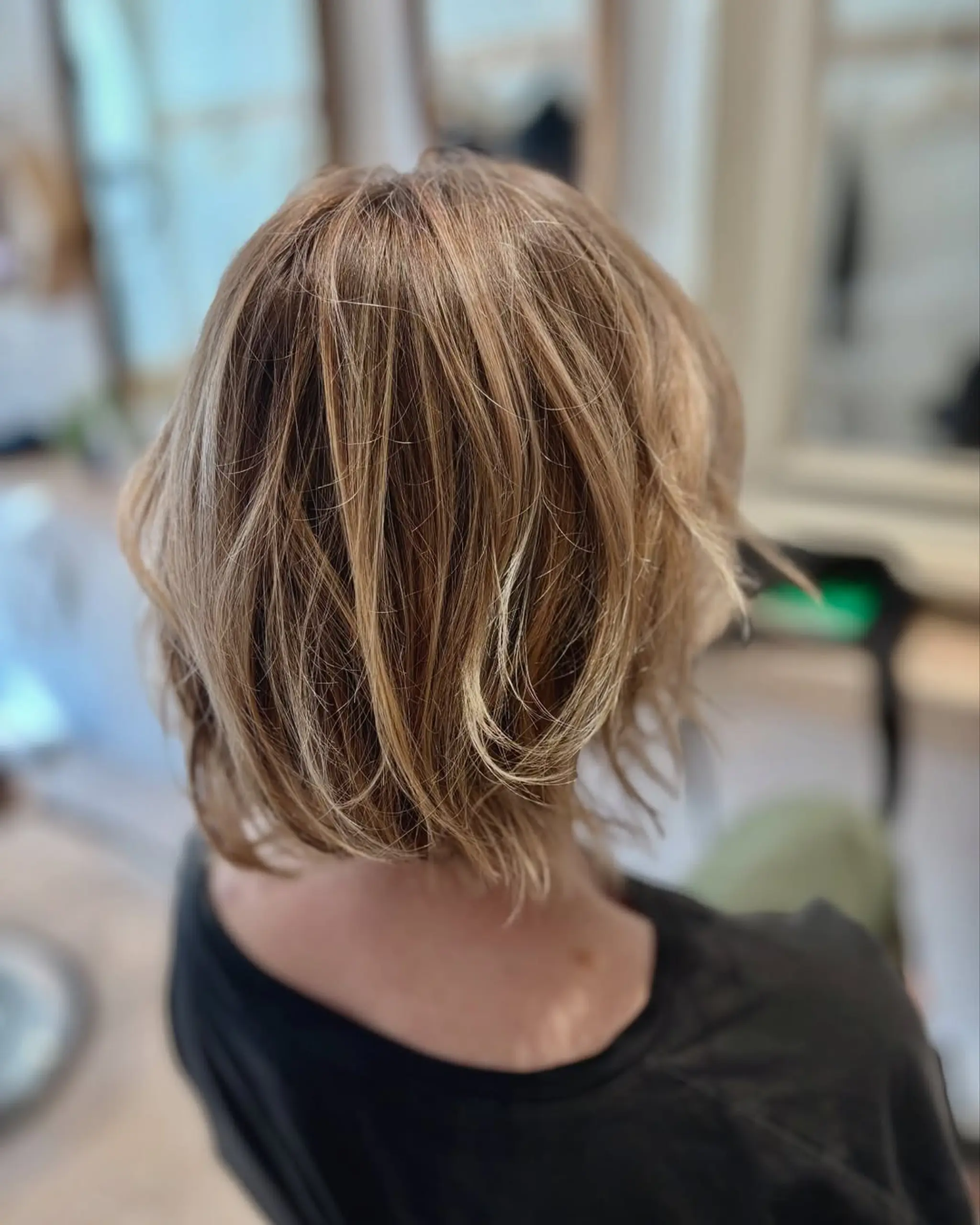 A short, layered bob with textured ends and subtle highlights. 2