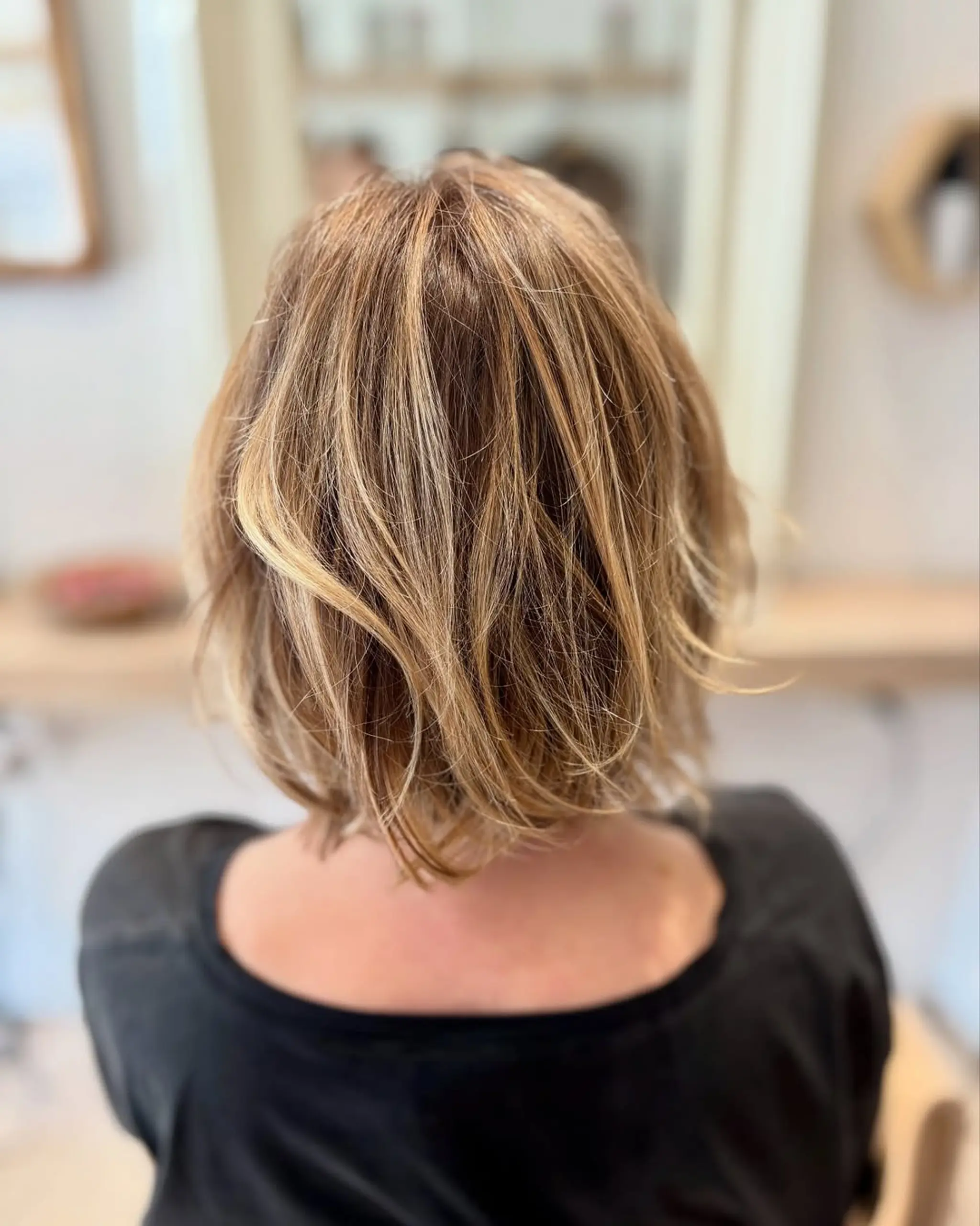 A short, layered bob with textured ends and subtle highlights. 3