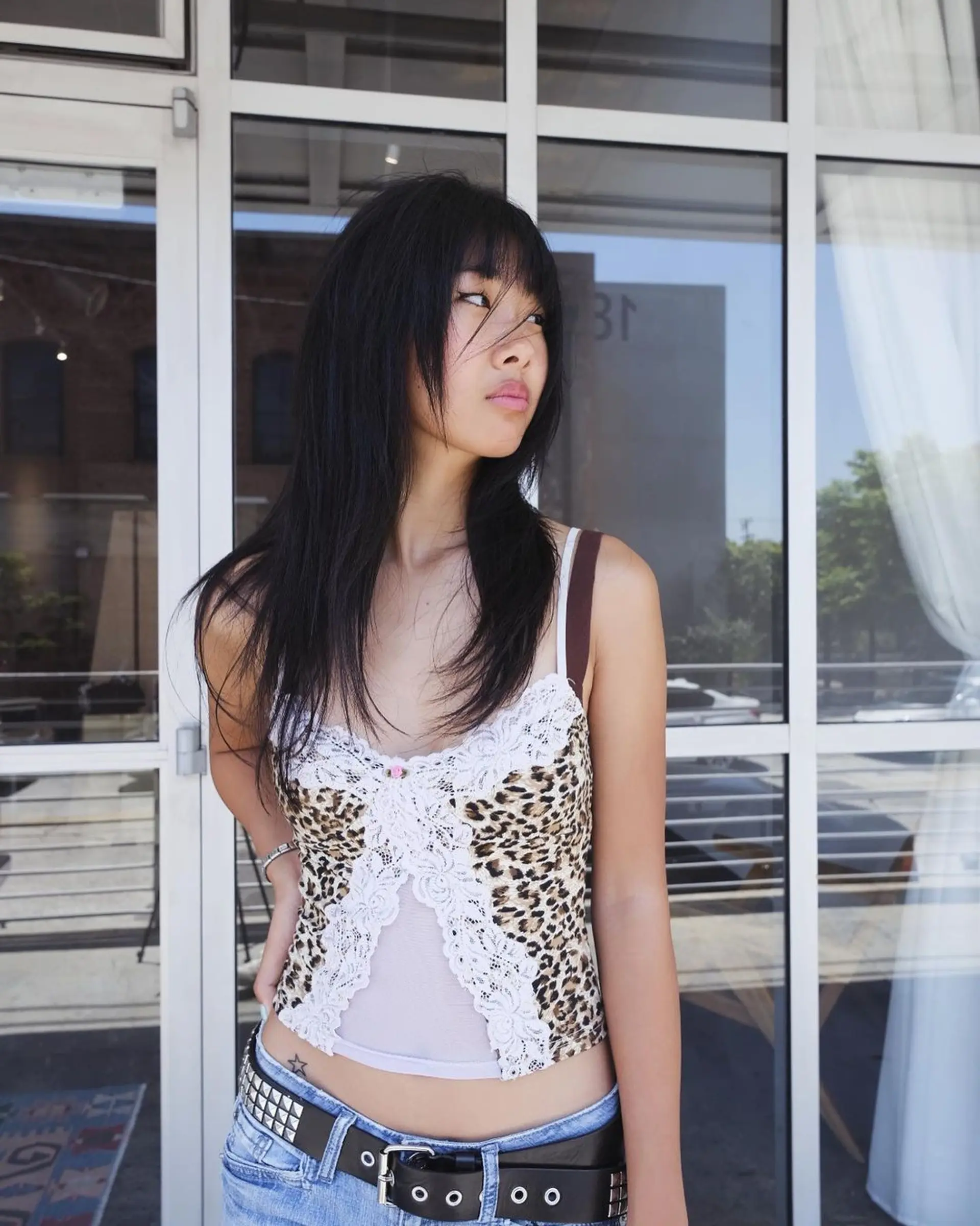 Medium-length, black straight hair with blunt bangs and face-framing layers, featuring a smooth, layered cut. 5